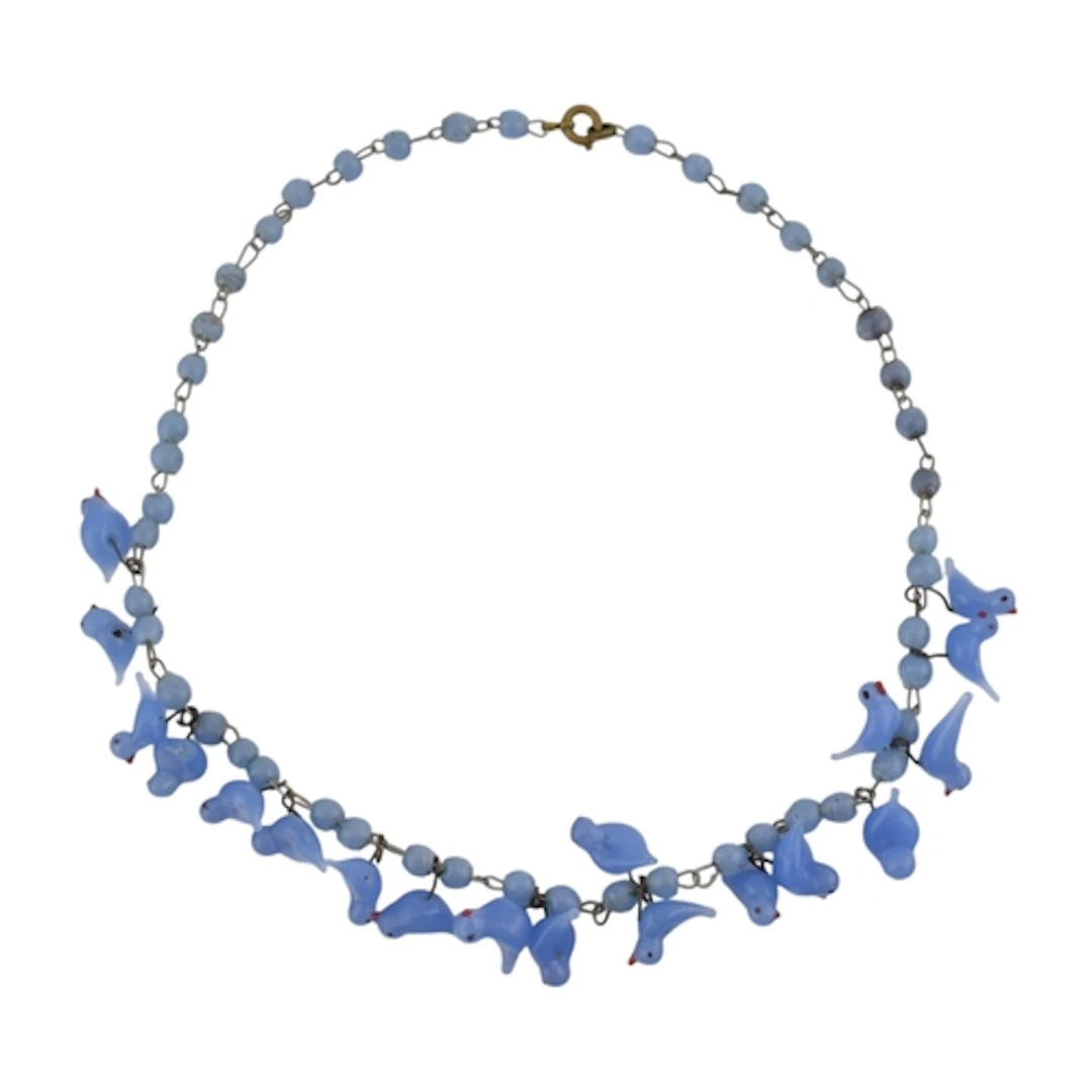 A vintage blue glass lampwork bird bead necklace. The neckla...