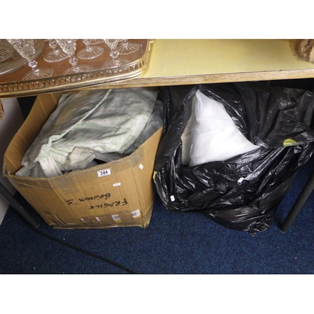 A hat together with a box of curtains and bag of cushion inn...