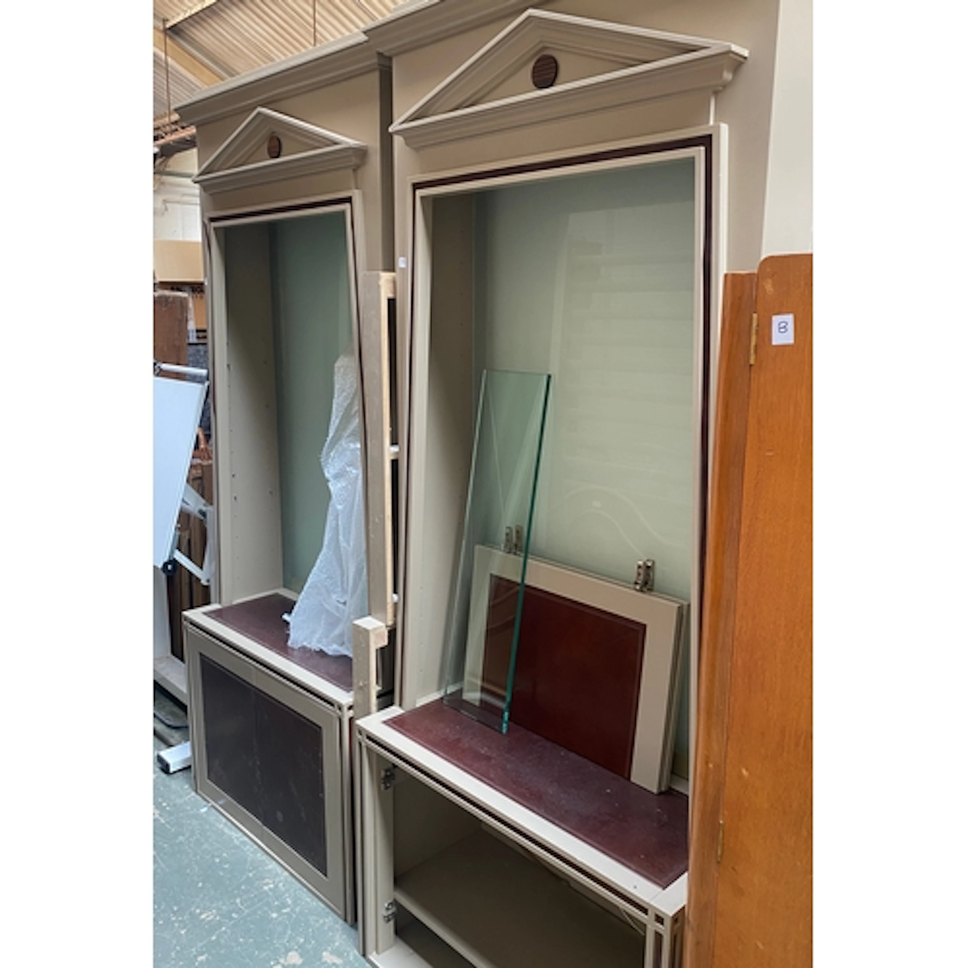 A pair of grey painted and leather inset bookcases, in 'Egyp...
