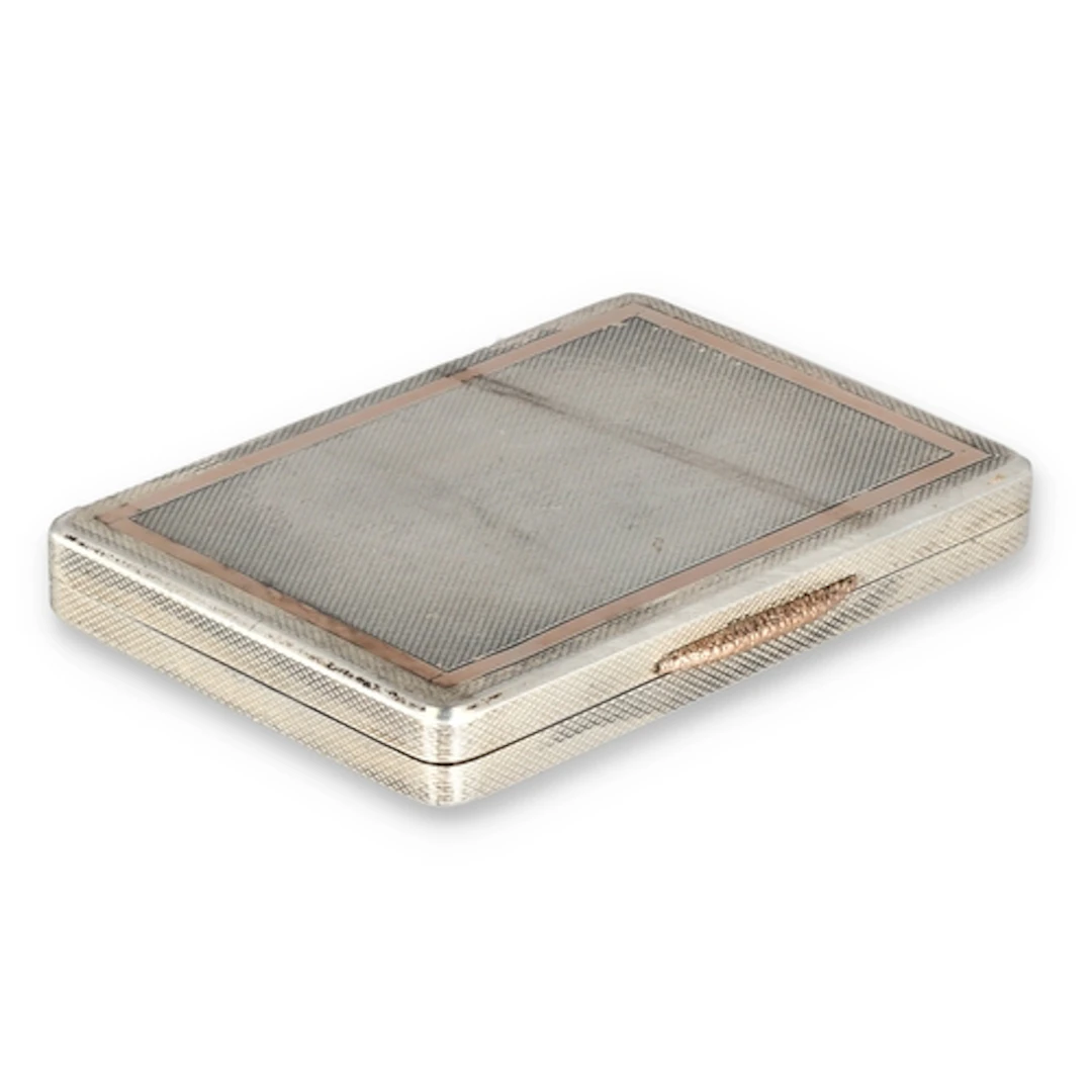 A SILVER AND 9CT GOLD INLAID CIGARETTE BOX With 9ct gold cl...