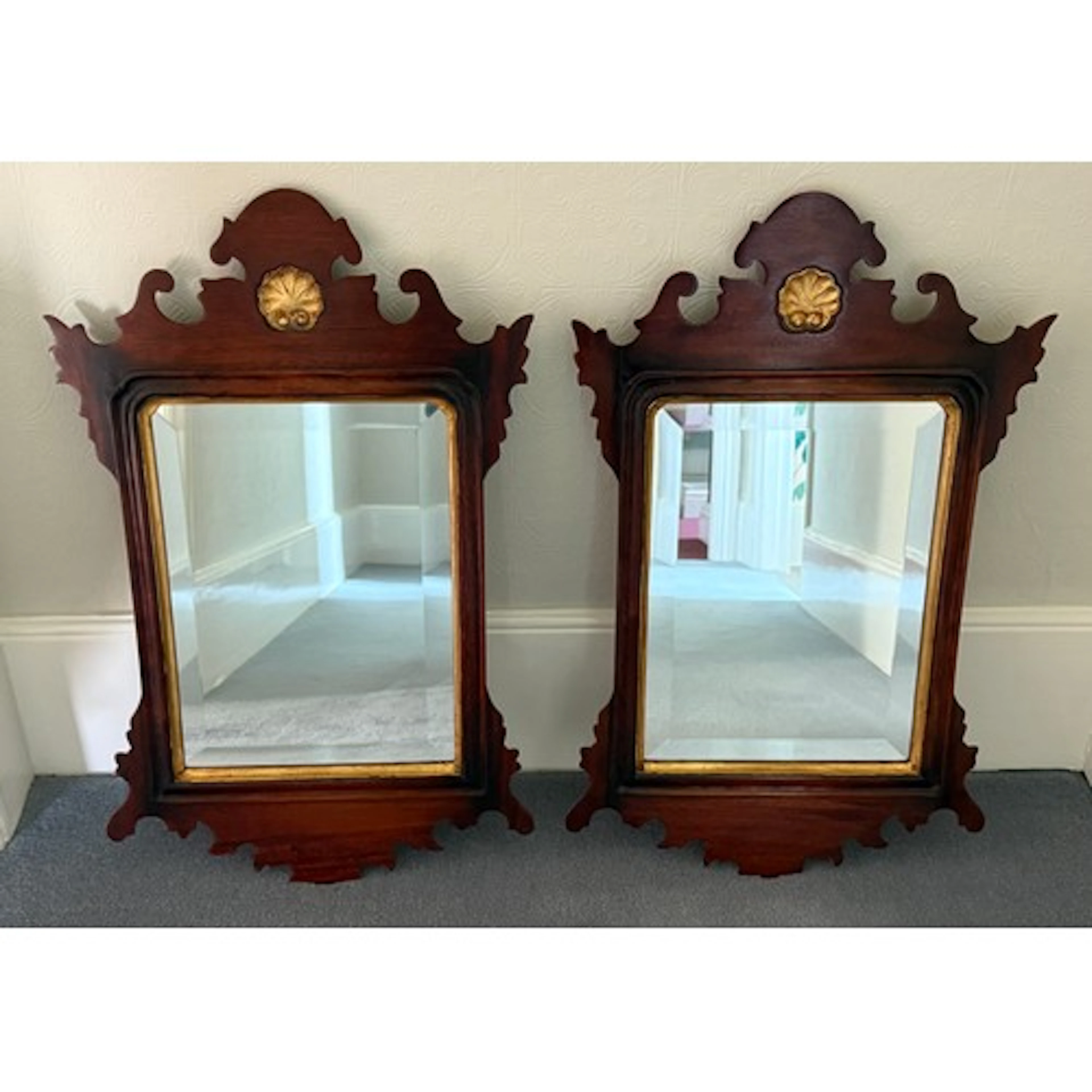 Two mahogany framed mirrors with bevelled glass and gilt she...