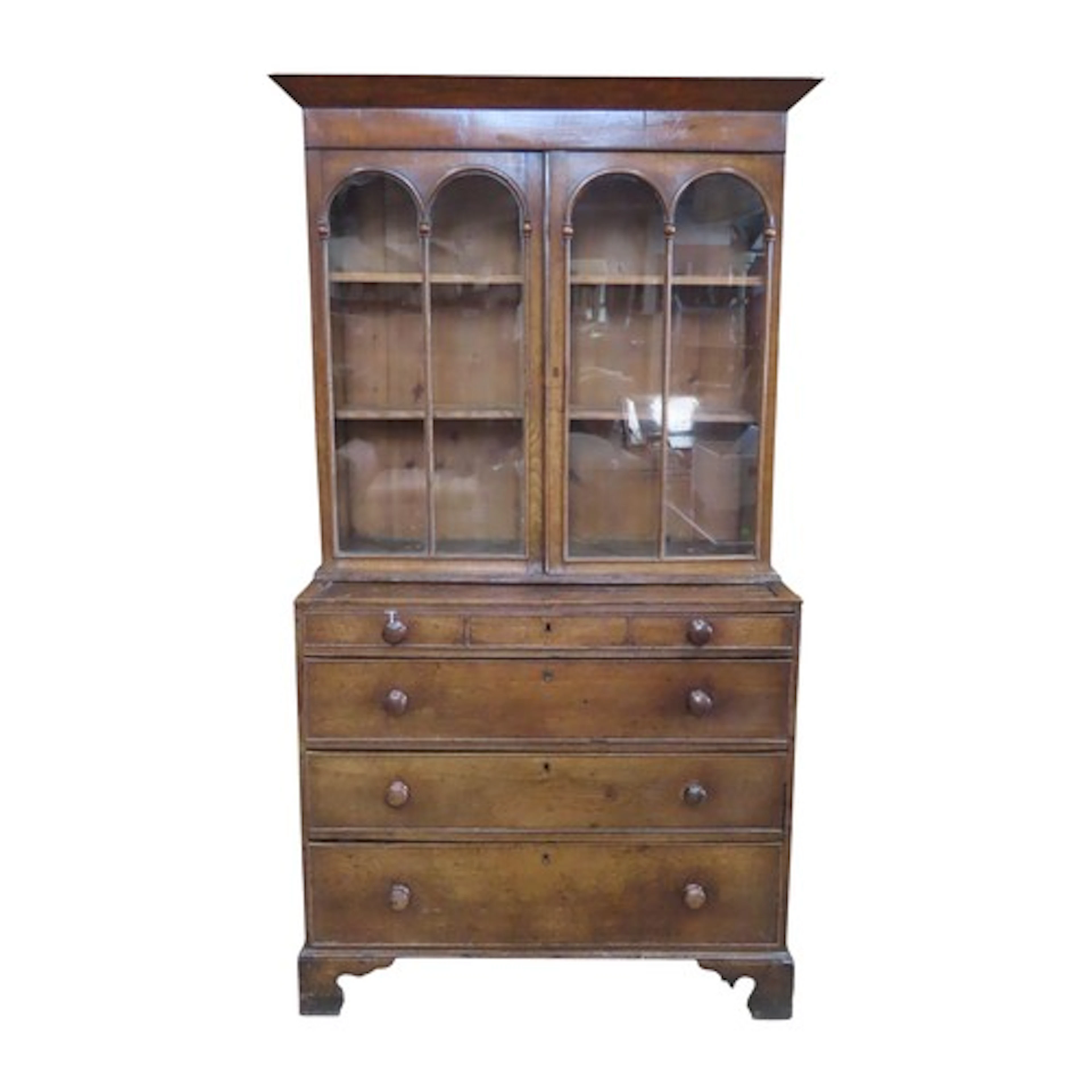 A good George III oak glazed bookcase over a chest of four ...