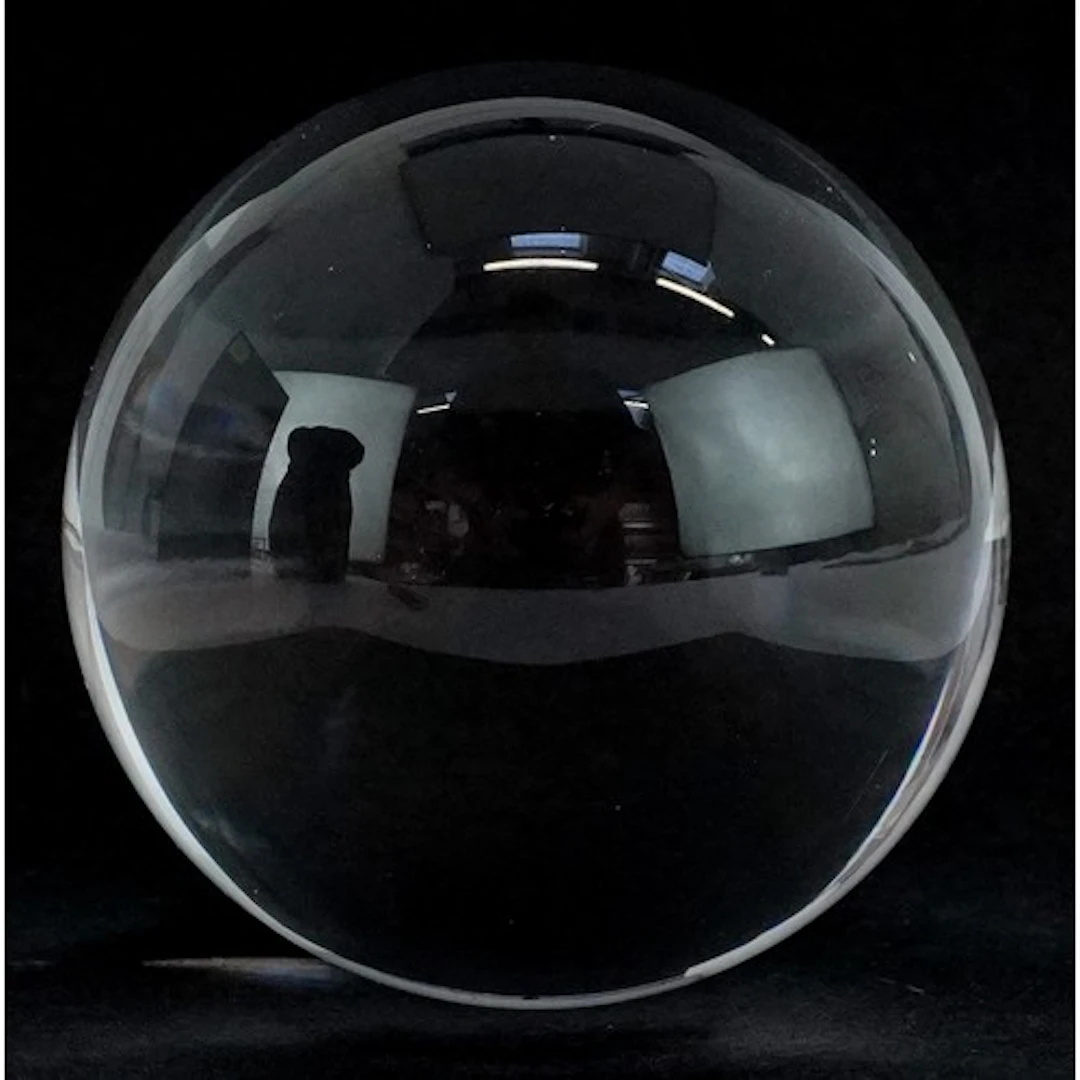 Crystal ball with velvet carrying bag, 6cm in diameter.