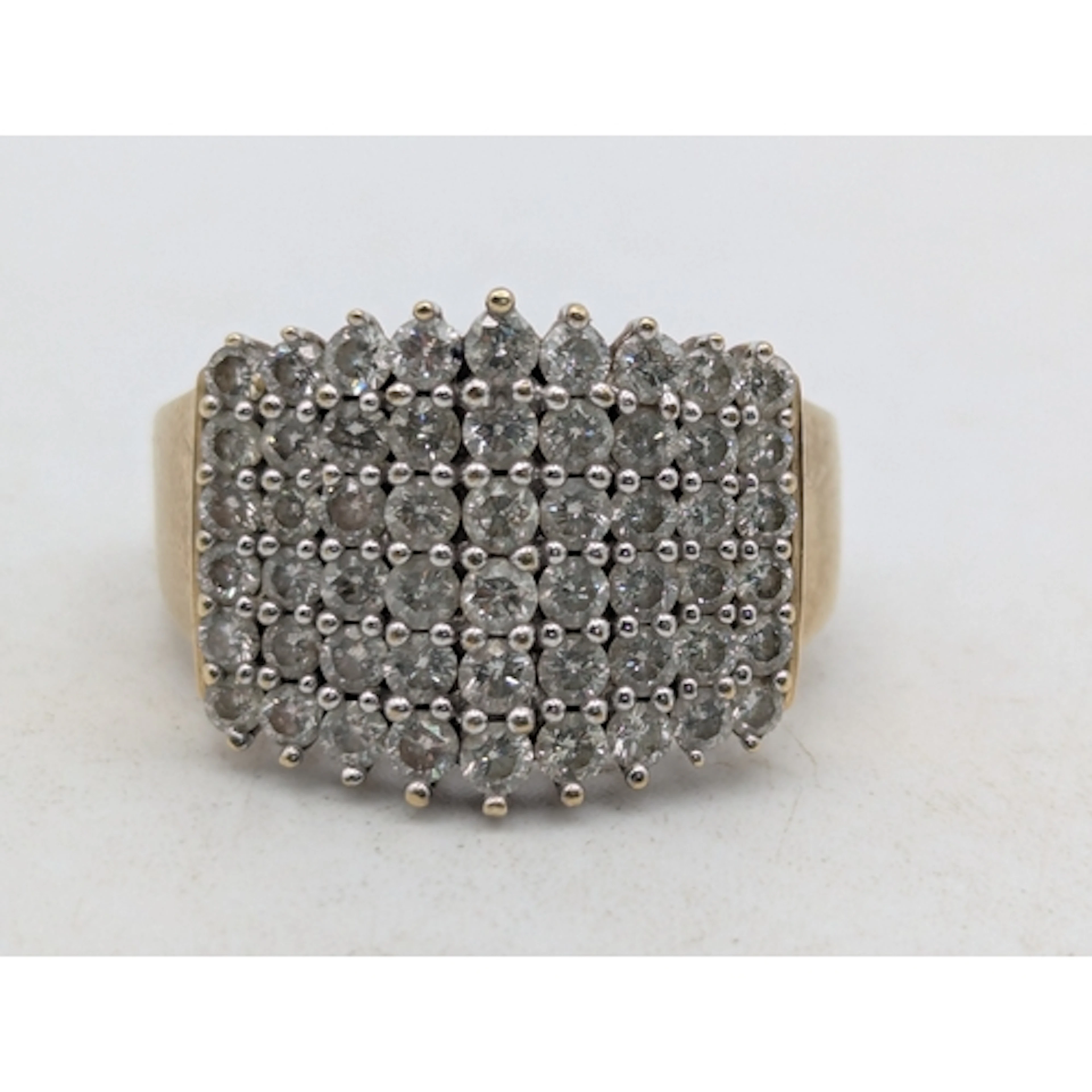A 9ct yellow and white gold multi-row diamond cluster cockta...