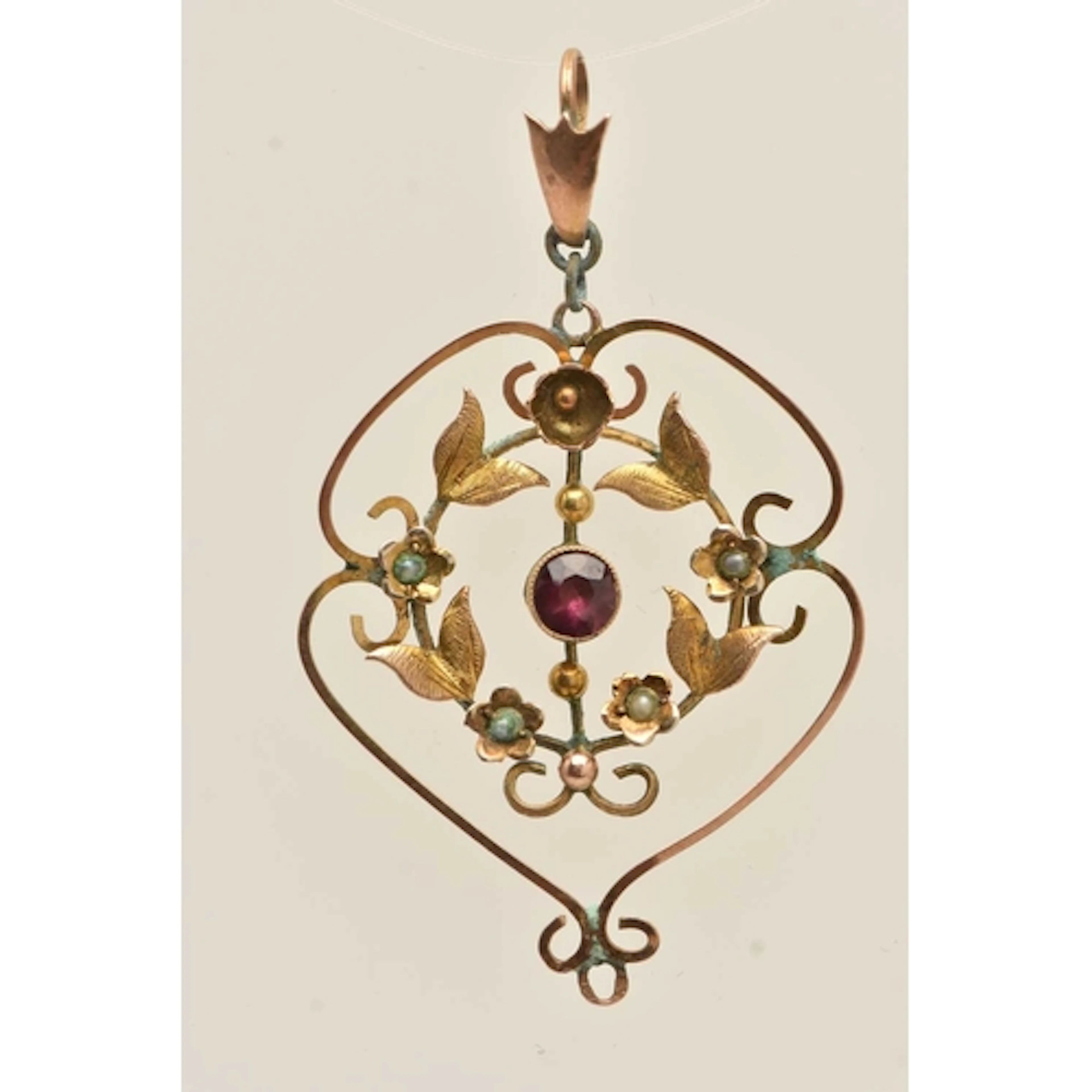 A YELLOW METAL LAVALIER PENDANT, open work pendant with flor...