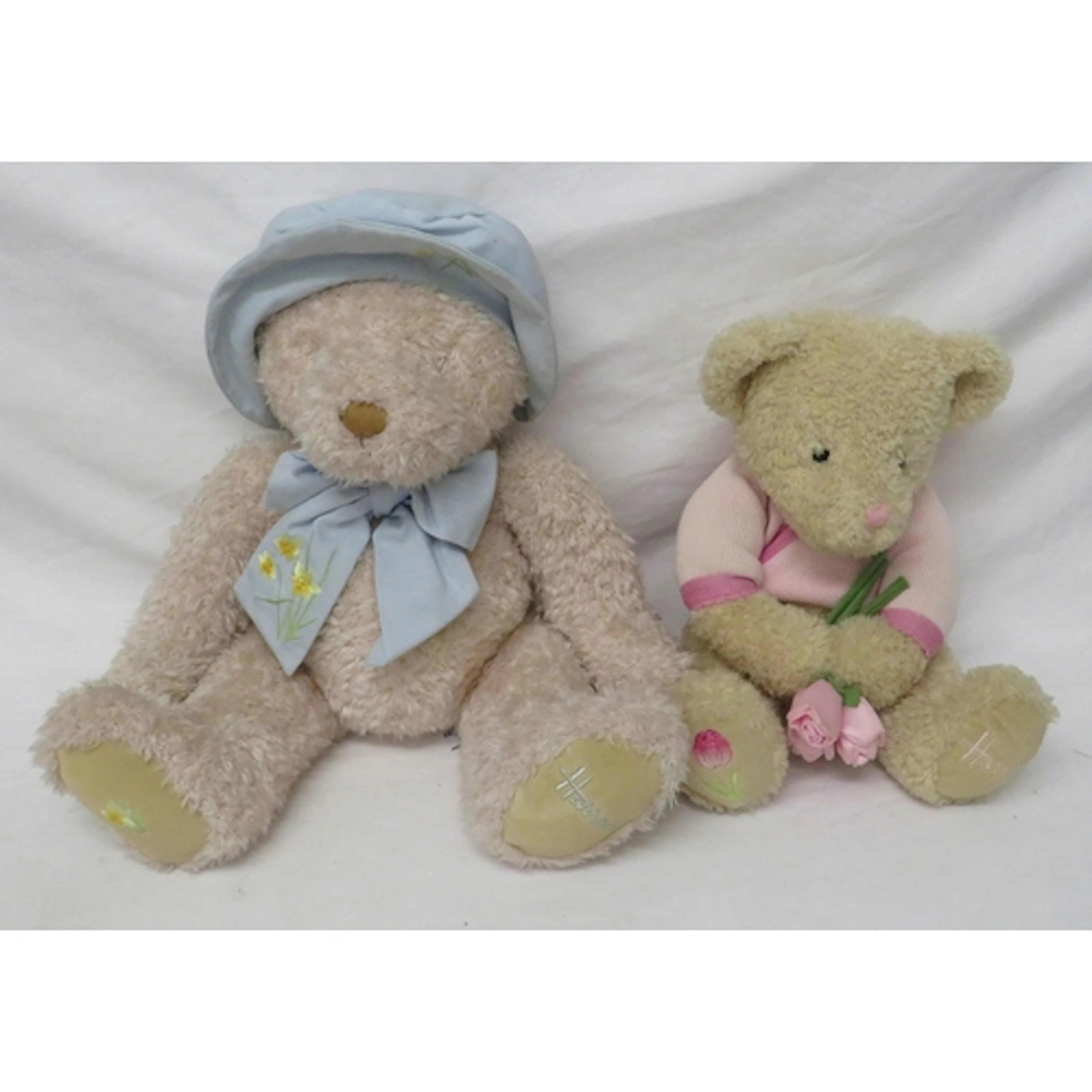 Light Coloured Pink/Beige Harrods Spring Bear wearing a blue...