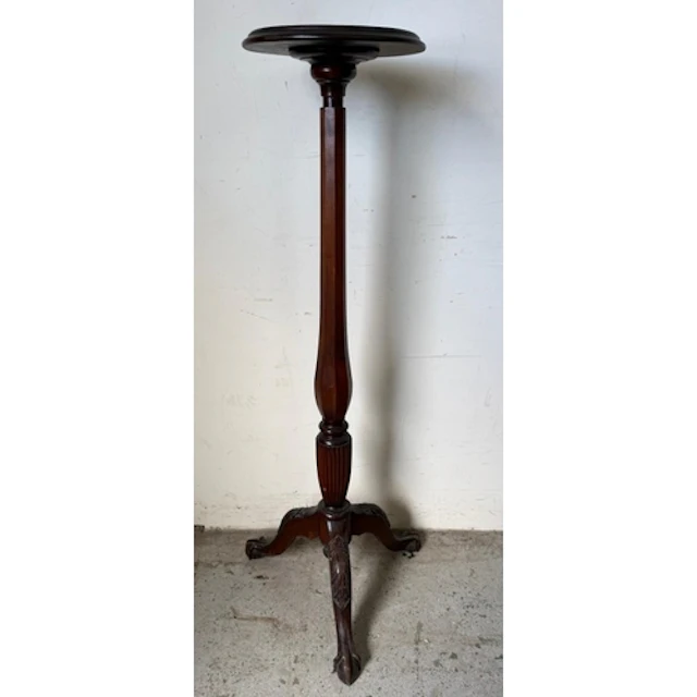 A Mahogany torchere stand or plant stand , circular top with...