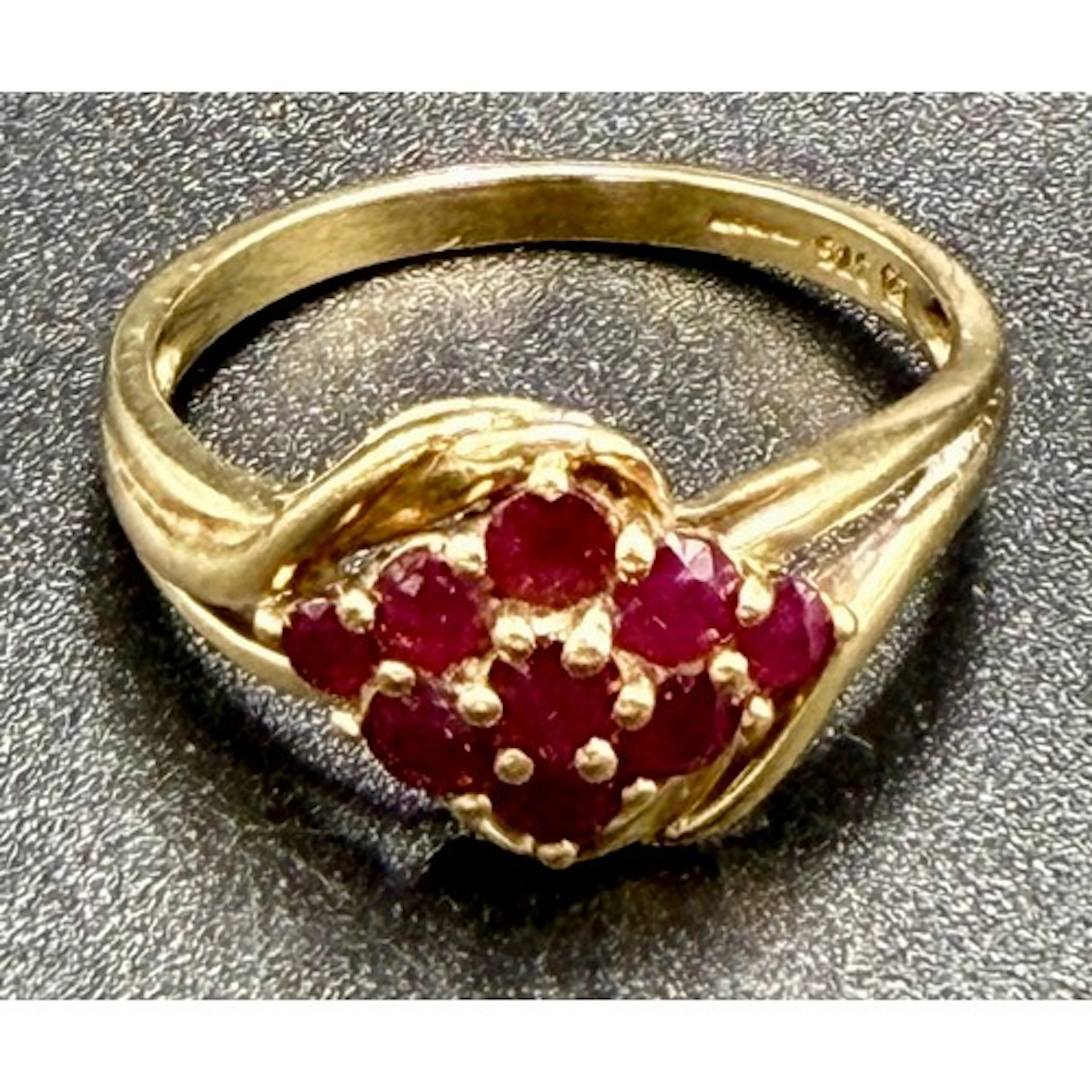 A 9 carat gold ring set with pink stones. Size R. Weight 3.2...