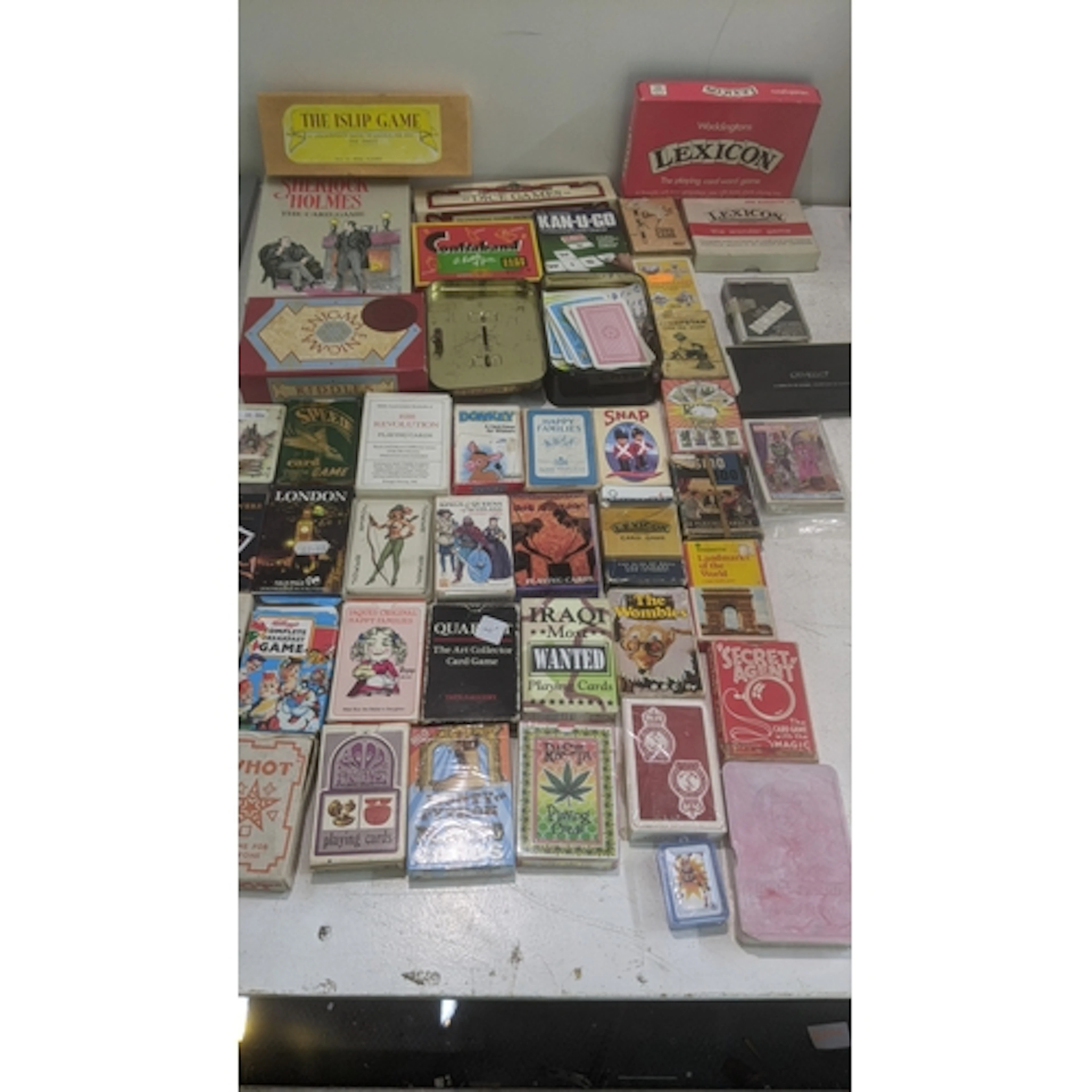 A collection of playing card sets and vintage card games to ...