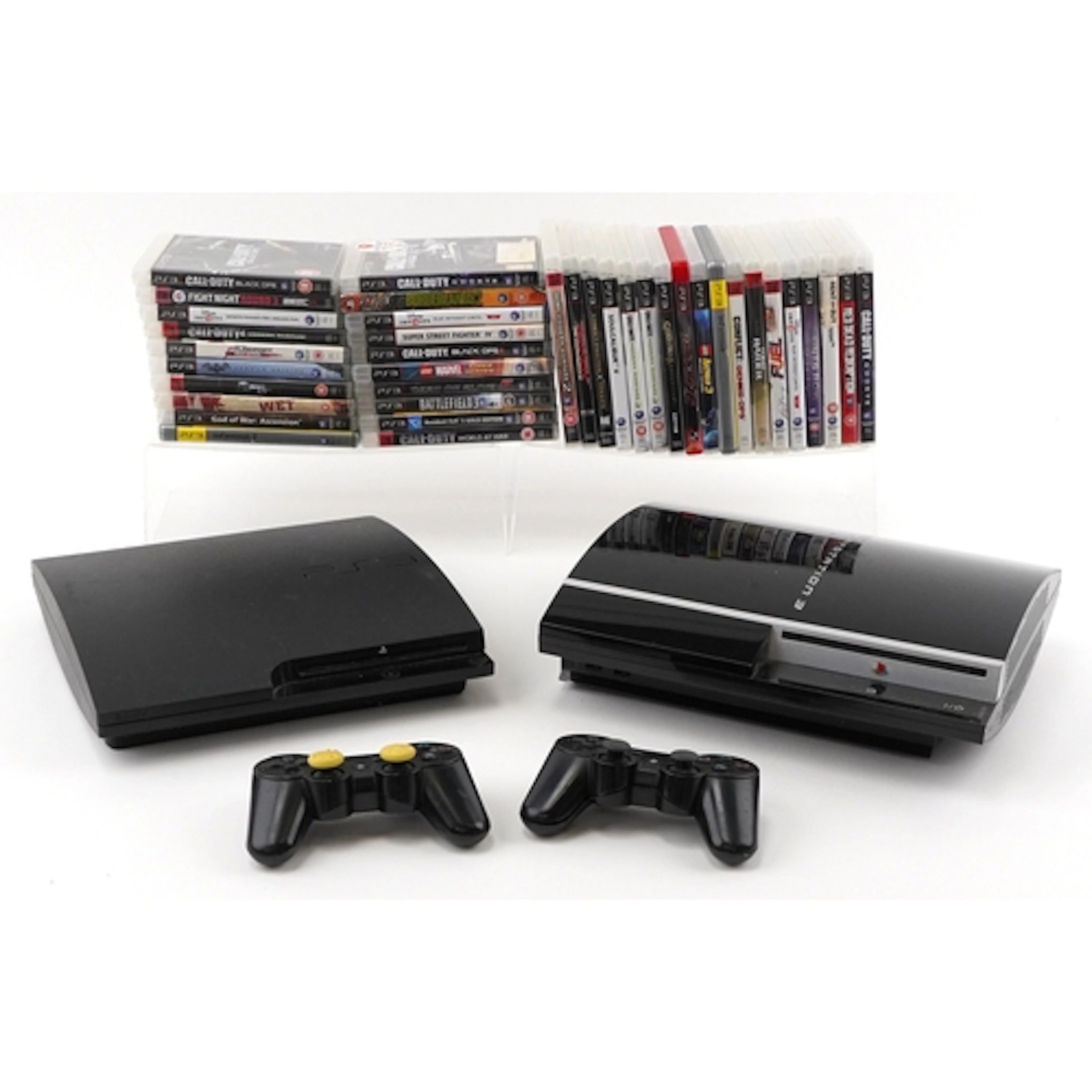 Two Sony PlayStation 3 games consoles with two controllers a...