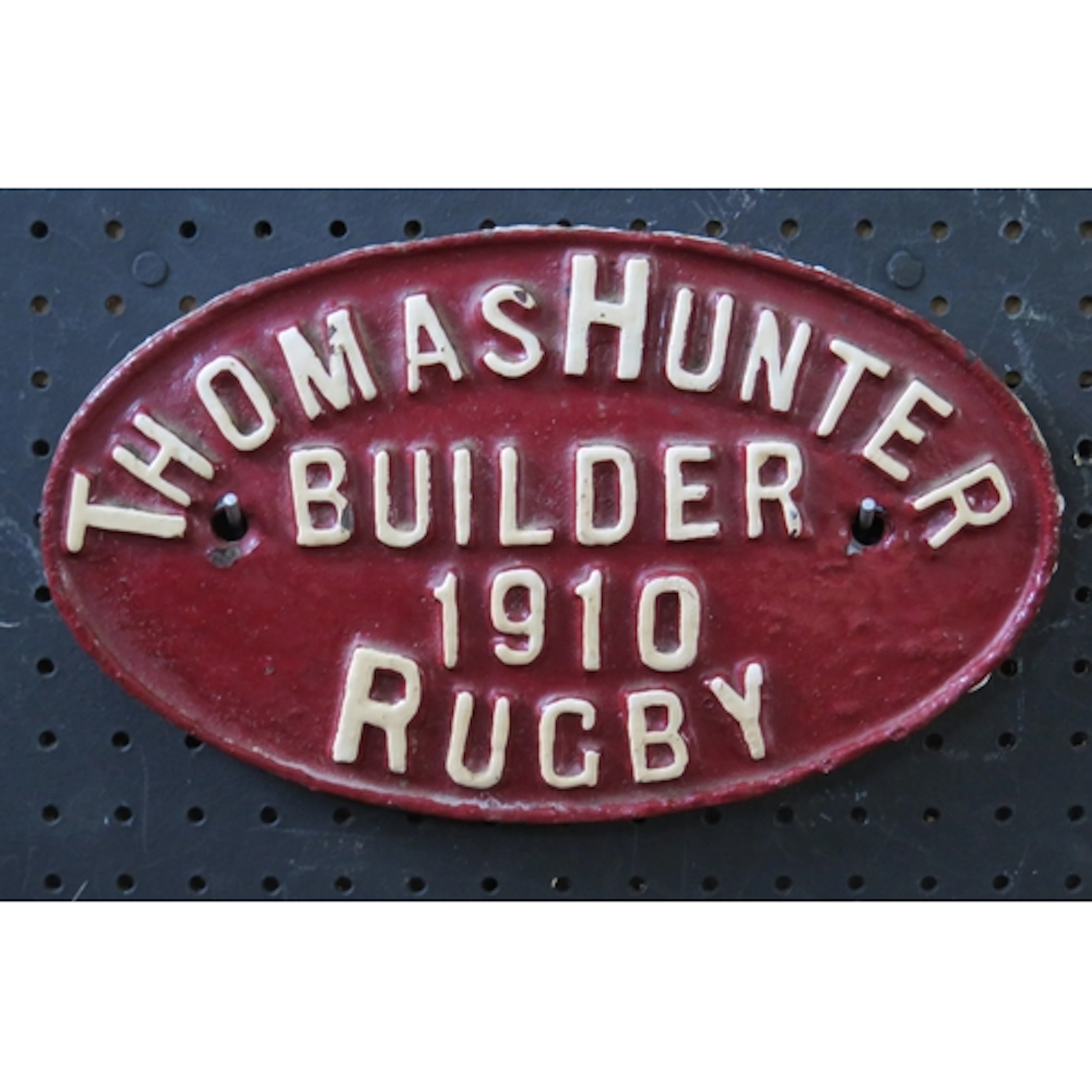 "Thomas Hunter Builder 1910 Rugby" - a cast iron wagon plate...