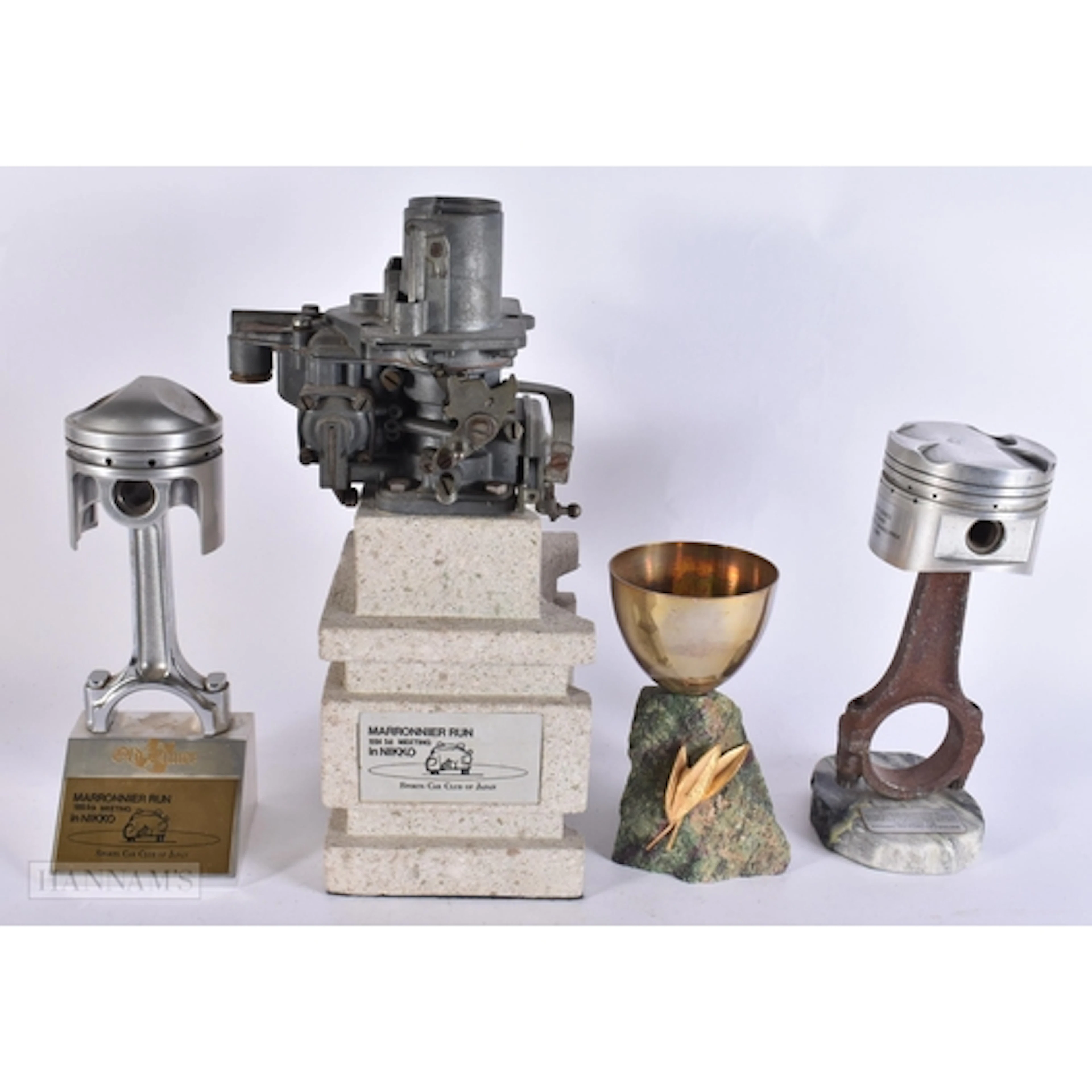 FOUR STYLISH AUTOMOTIVE RACING TROPHIES including the Americ...