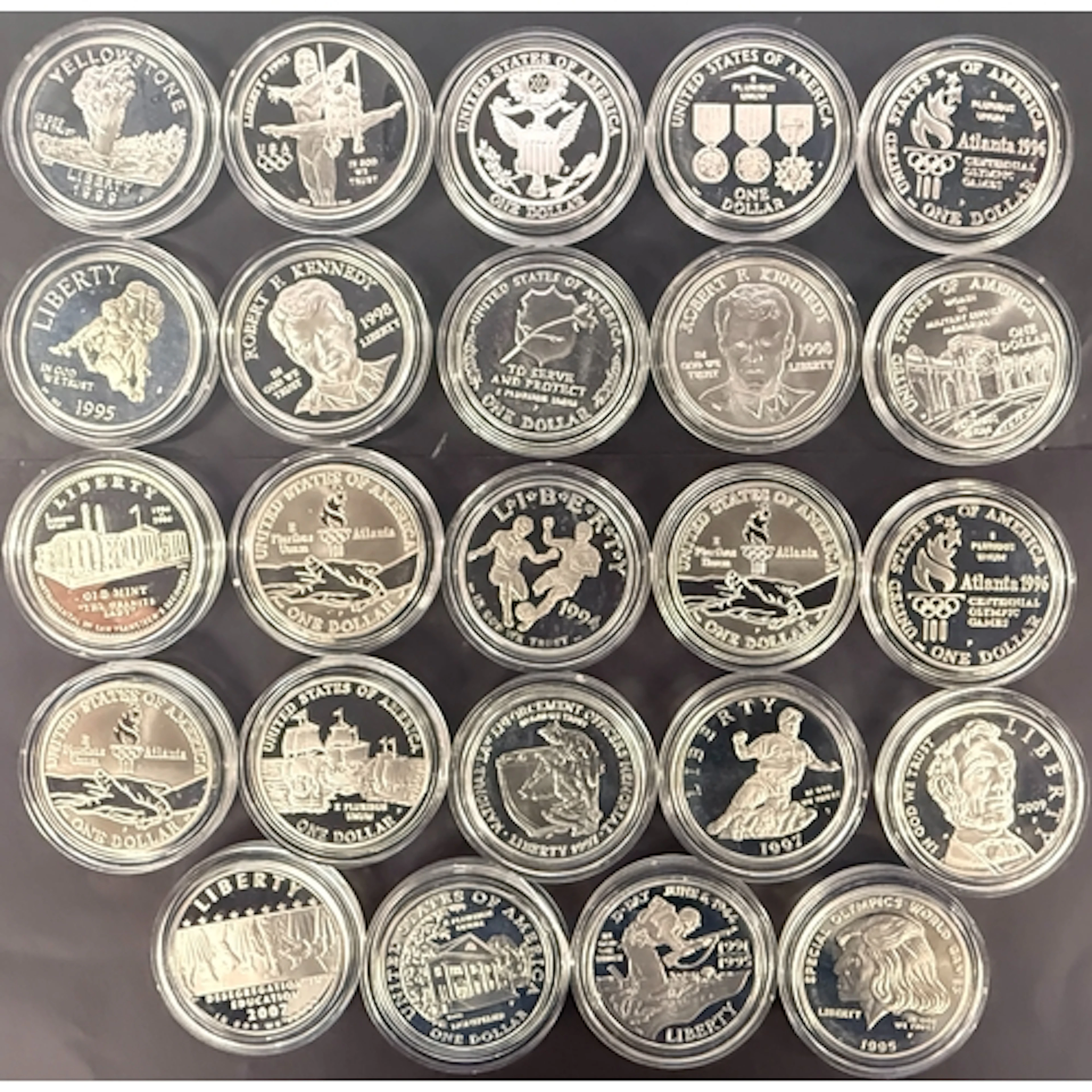 A collection of 24 encapsulated uncirculated USA commemorati...
