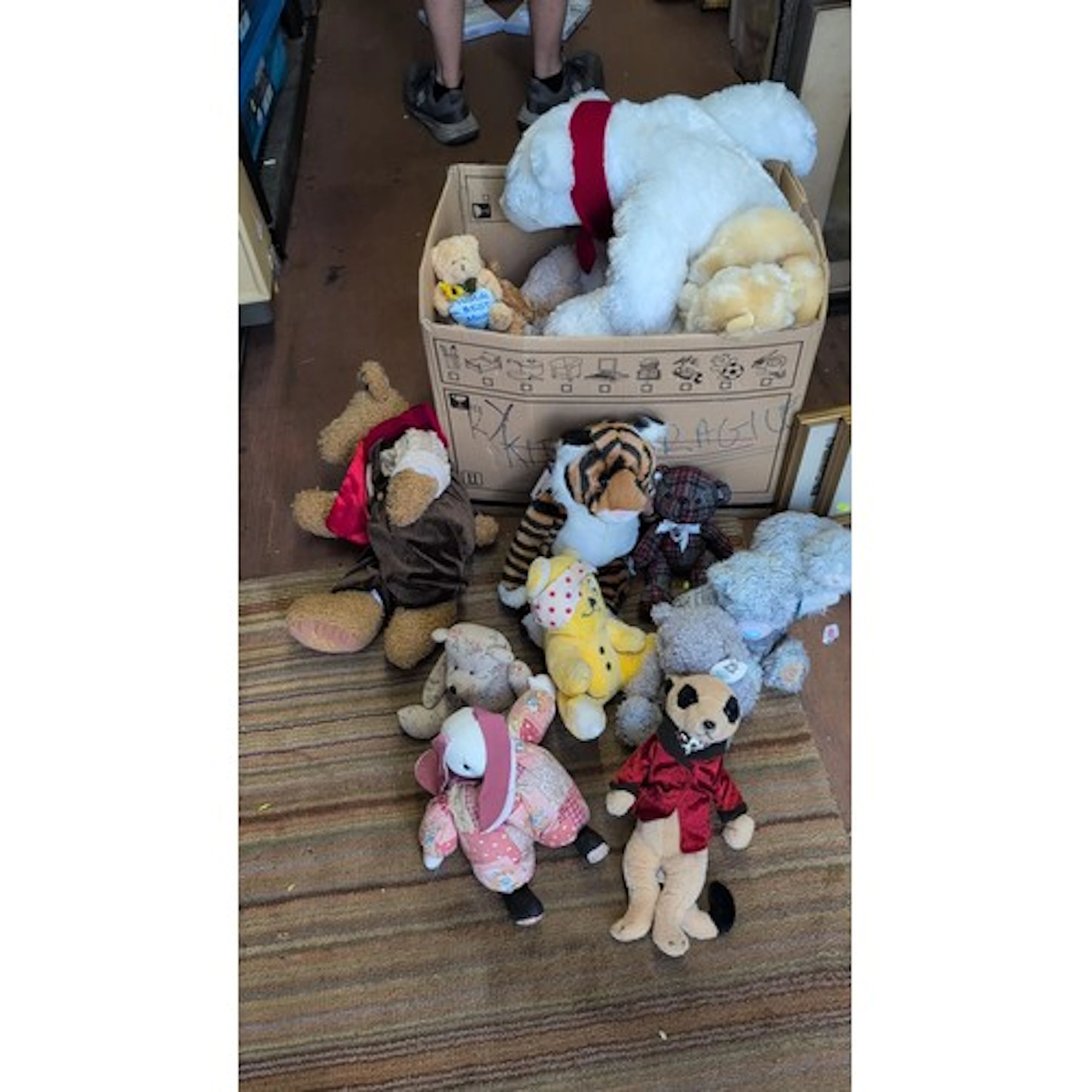 A group of plush toys including teddy bears, tiger, panda, e...