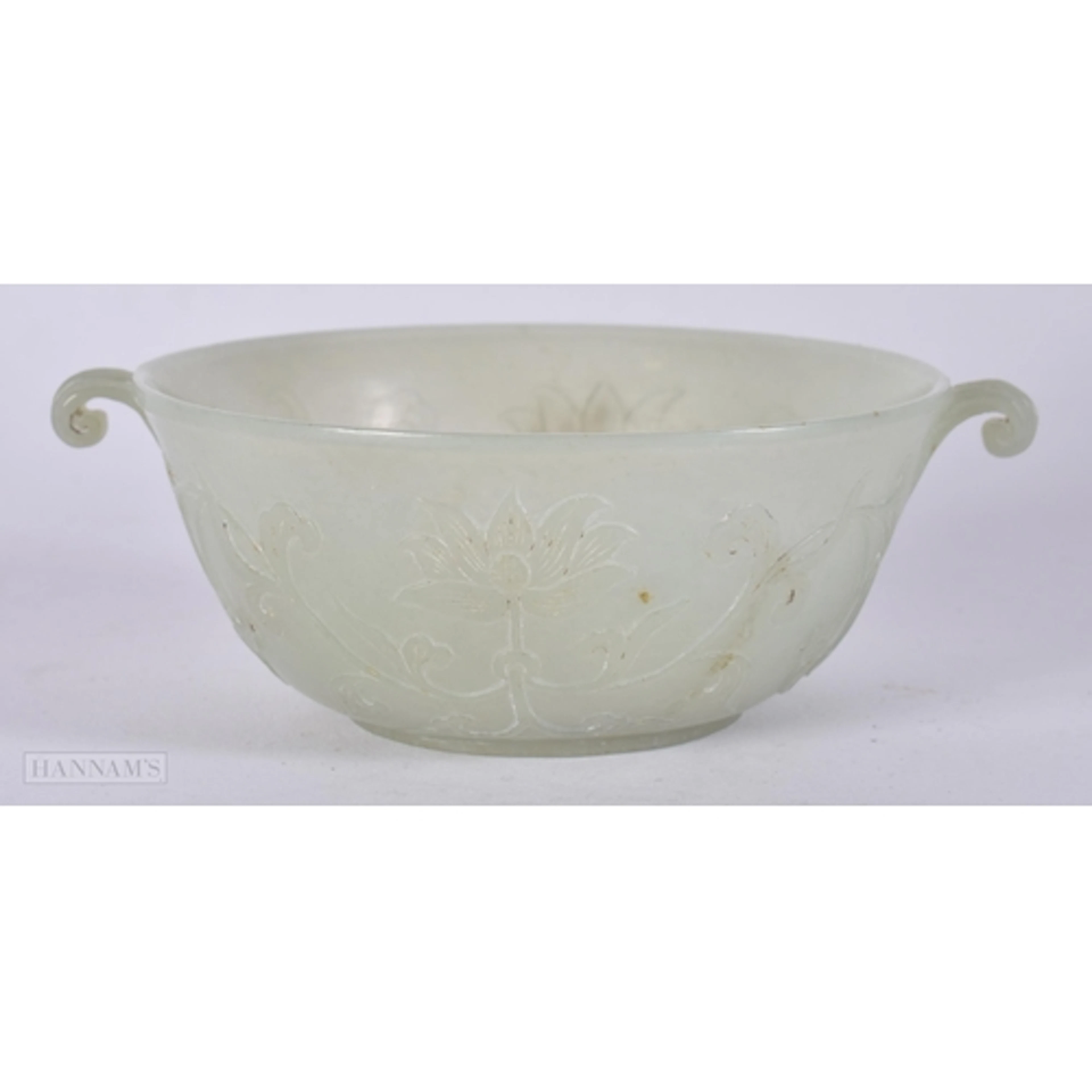 AN 18TH CENTURY CHINESE TWIN HANDLED GREEN JADE BOWL Qianlon...