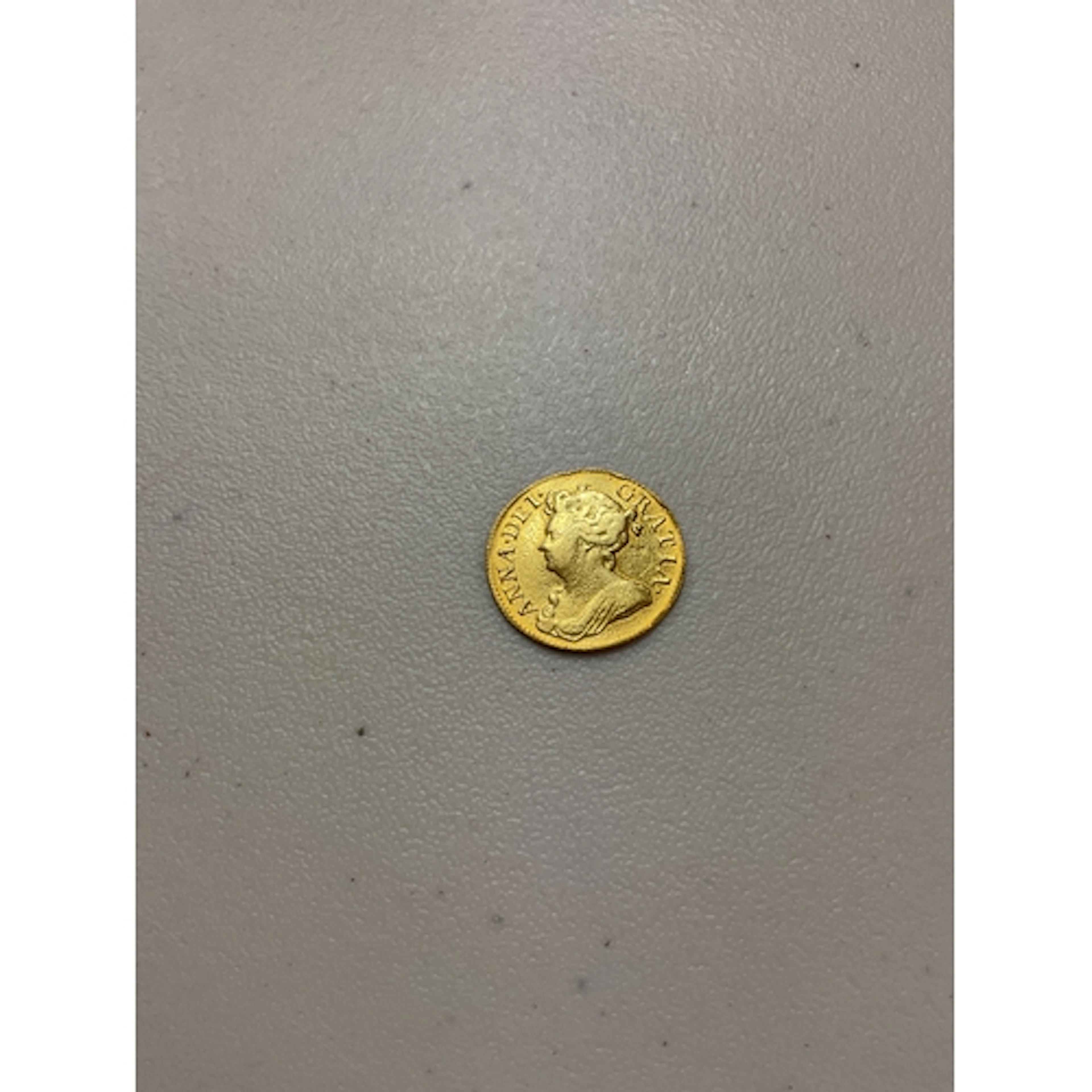 1714 Queen Anne Guinea, weight 8.1 grams.
