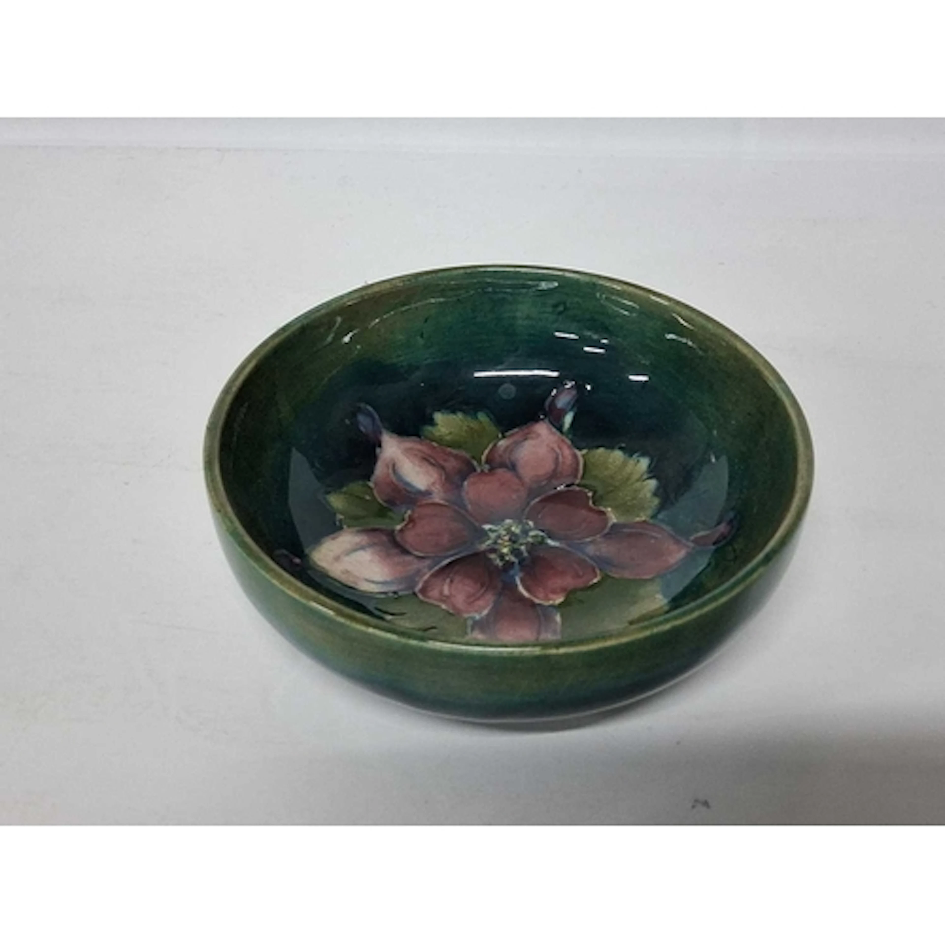 A MOORCROFT POTTERY COLUMBINE PATTERN BOWL, the footed bowl ...