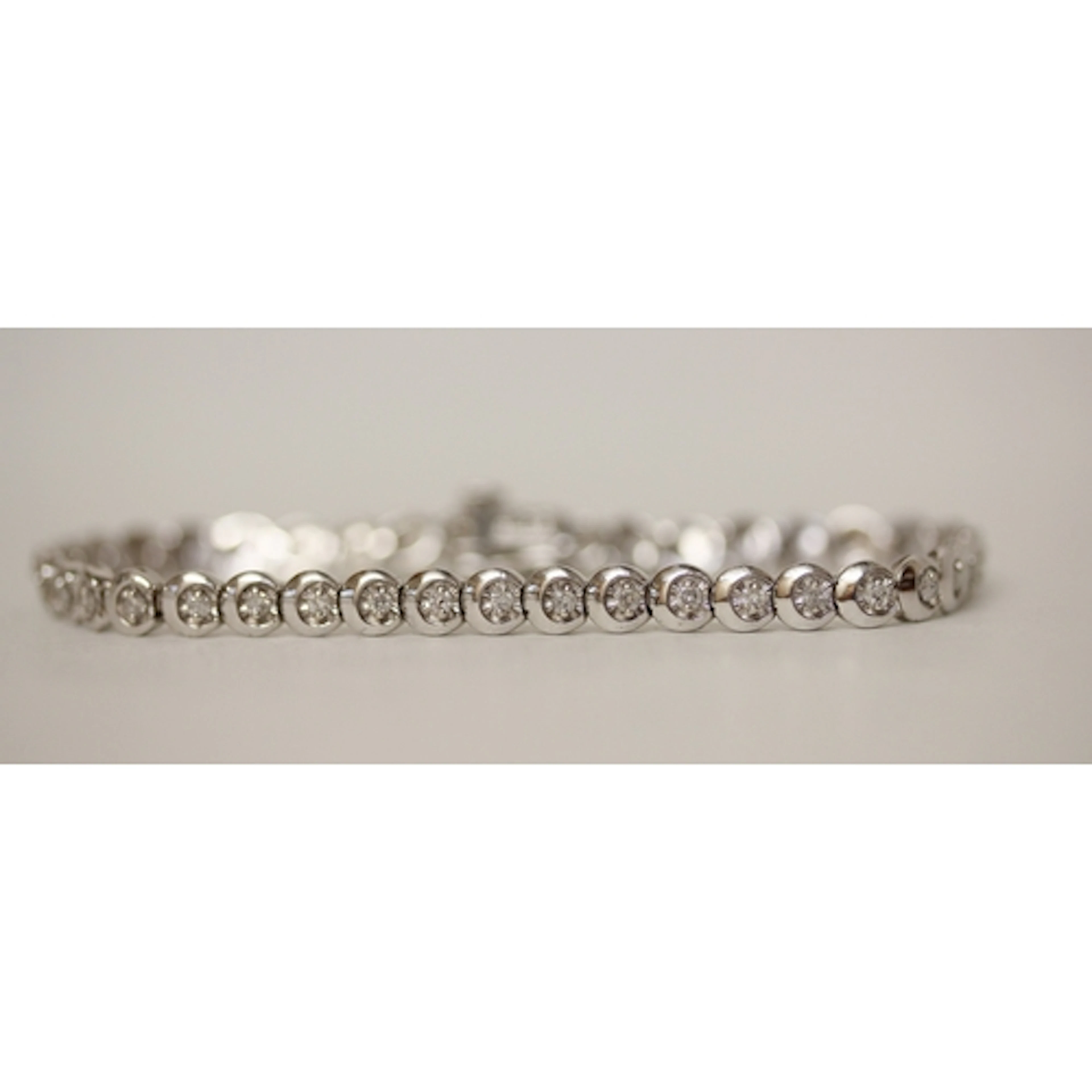 Modern 9ct white gold diamond set tennis bracelet, hallmarke...