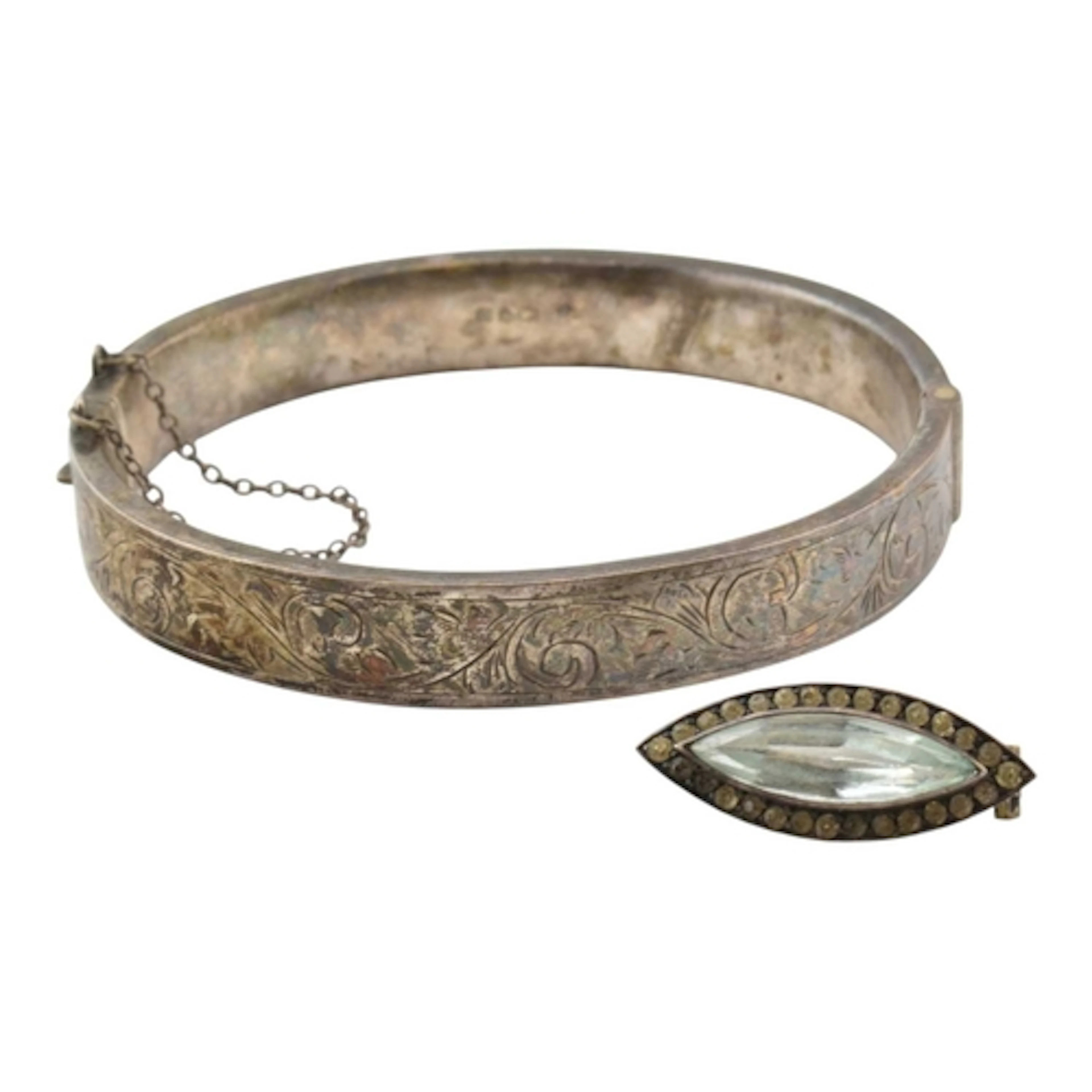 A hallmarked silver bangle with etched floral decoration and...