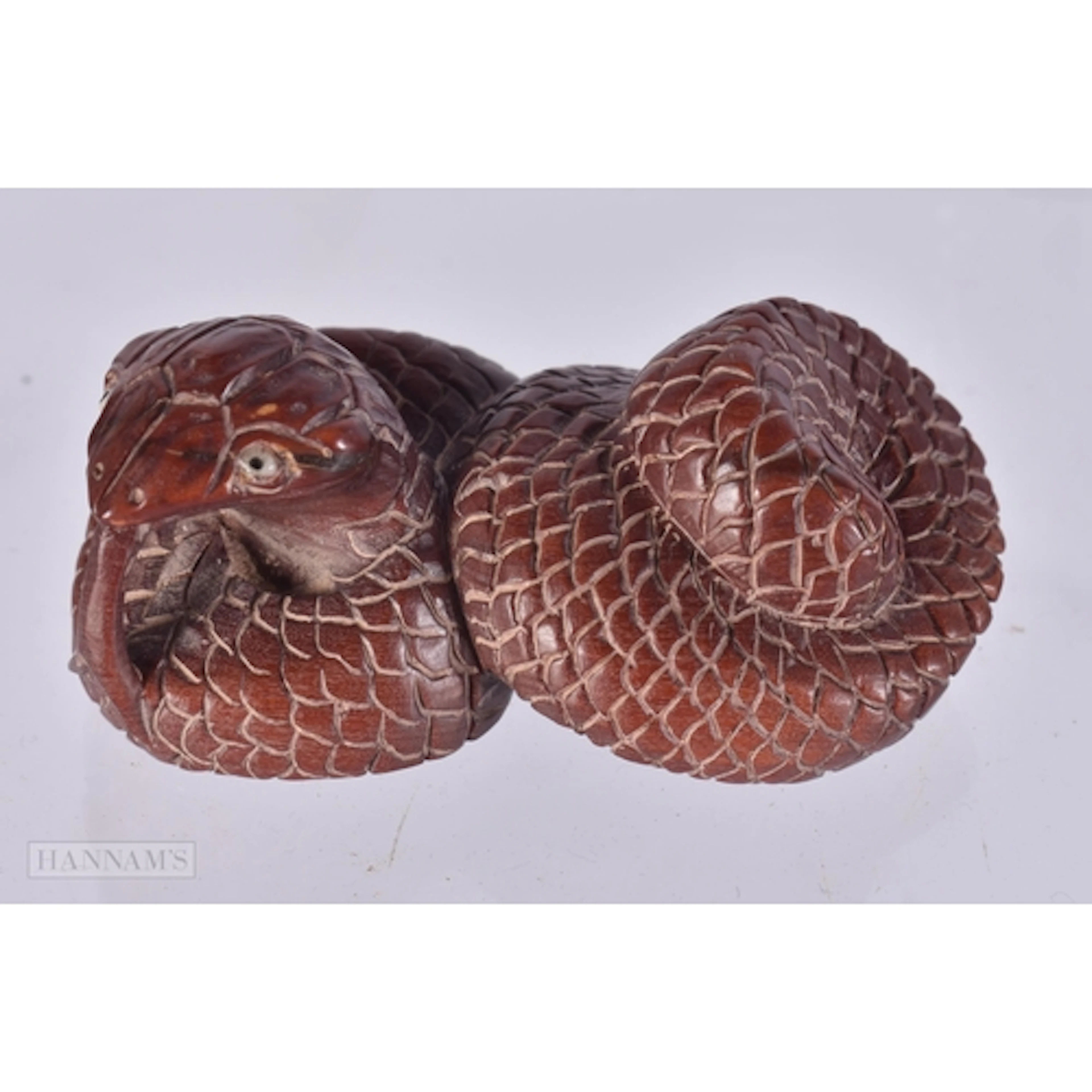 A CARVED WOOD SNAKE NETSUKE. 2.7 x 2.4 x 5.2 cm