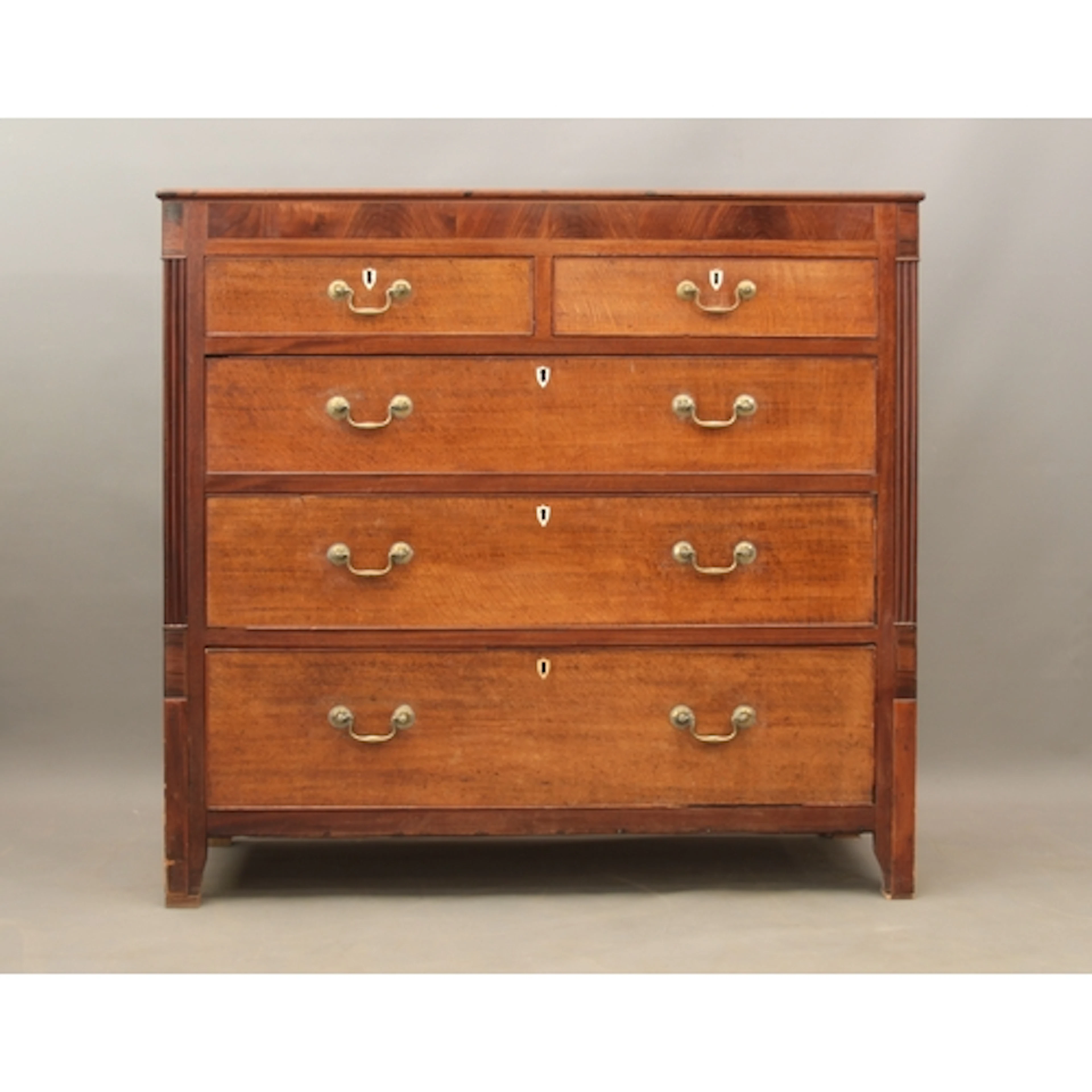 A late-Regency oak and mahogany straight front chest of draw...