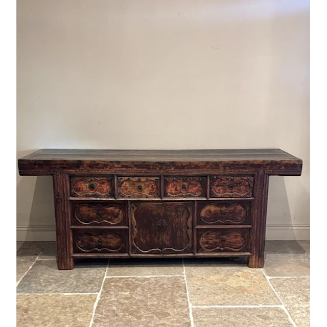 A large Chinese carved elm sideboard, painted with polychrom...