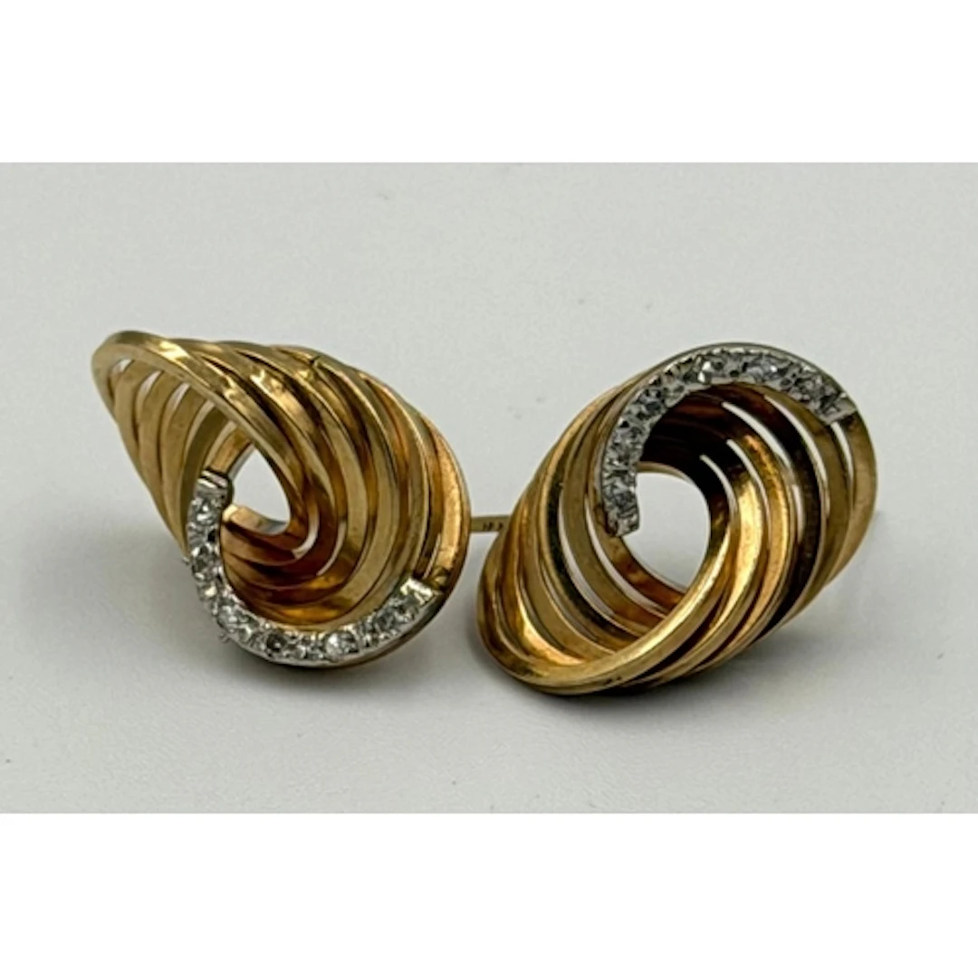 A pair of 14ct gold and diamond swirl themed earrings, appro...