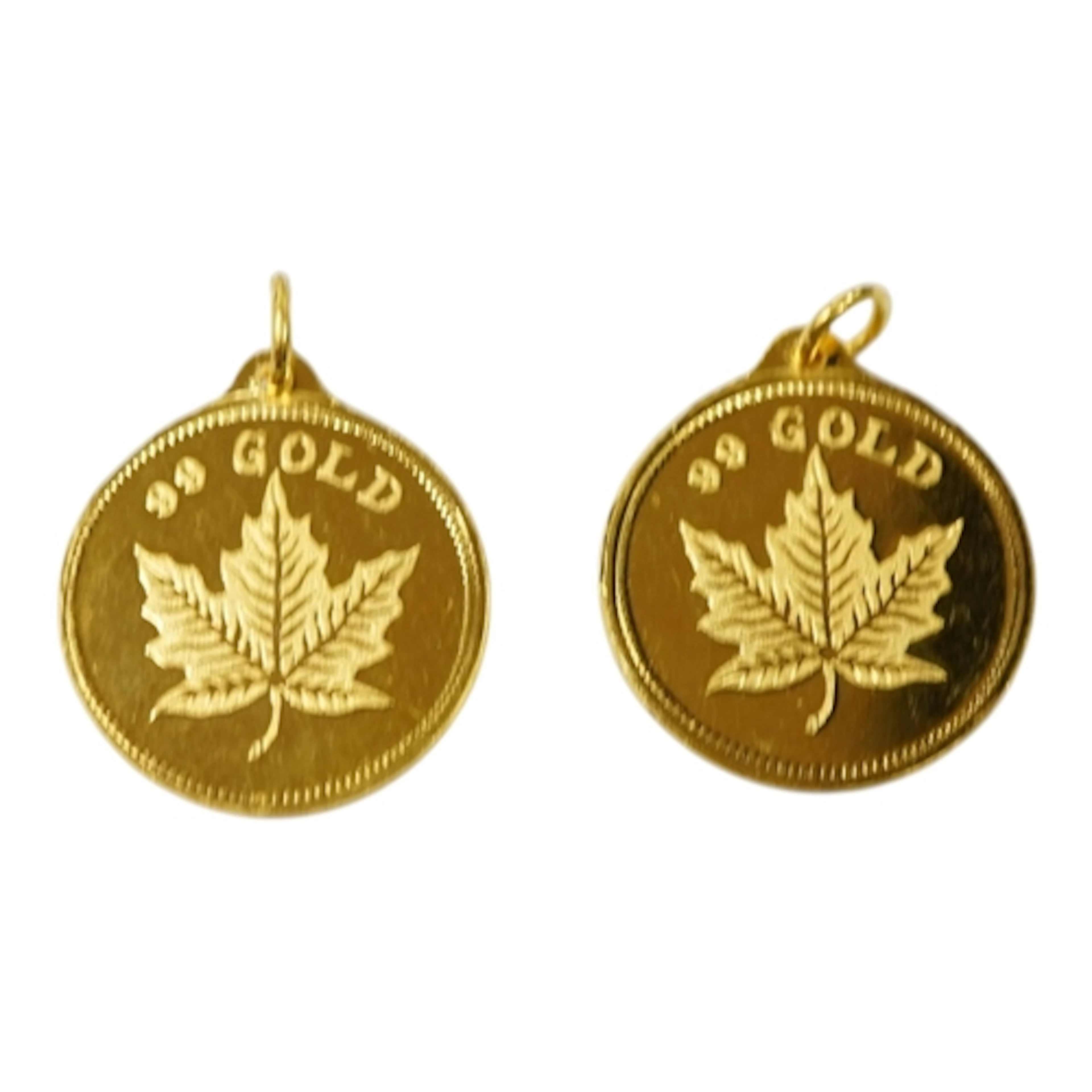 A pair of yellow metal circular zodiac dragon pendants, both...
