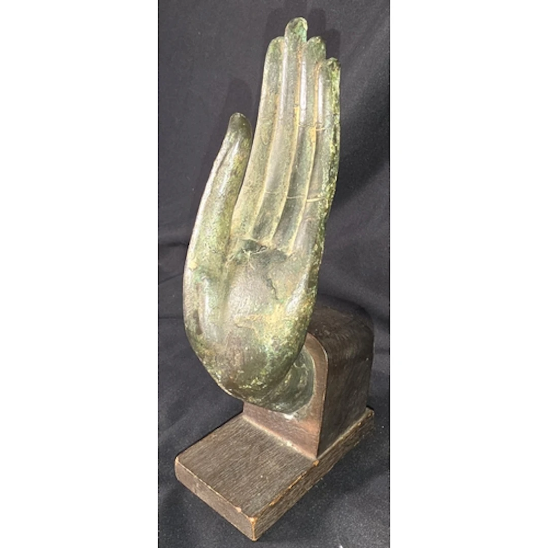 A bronze Buddhist palm mounted on a wooden block, height 23c...
