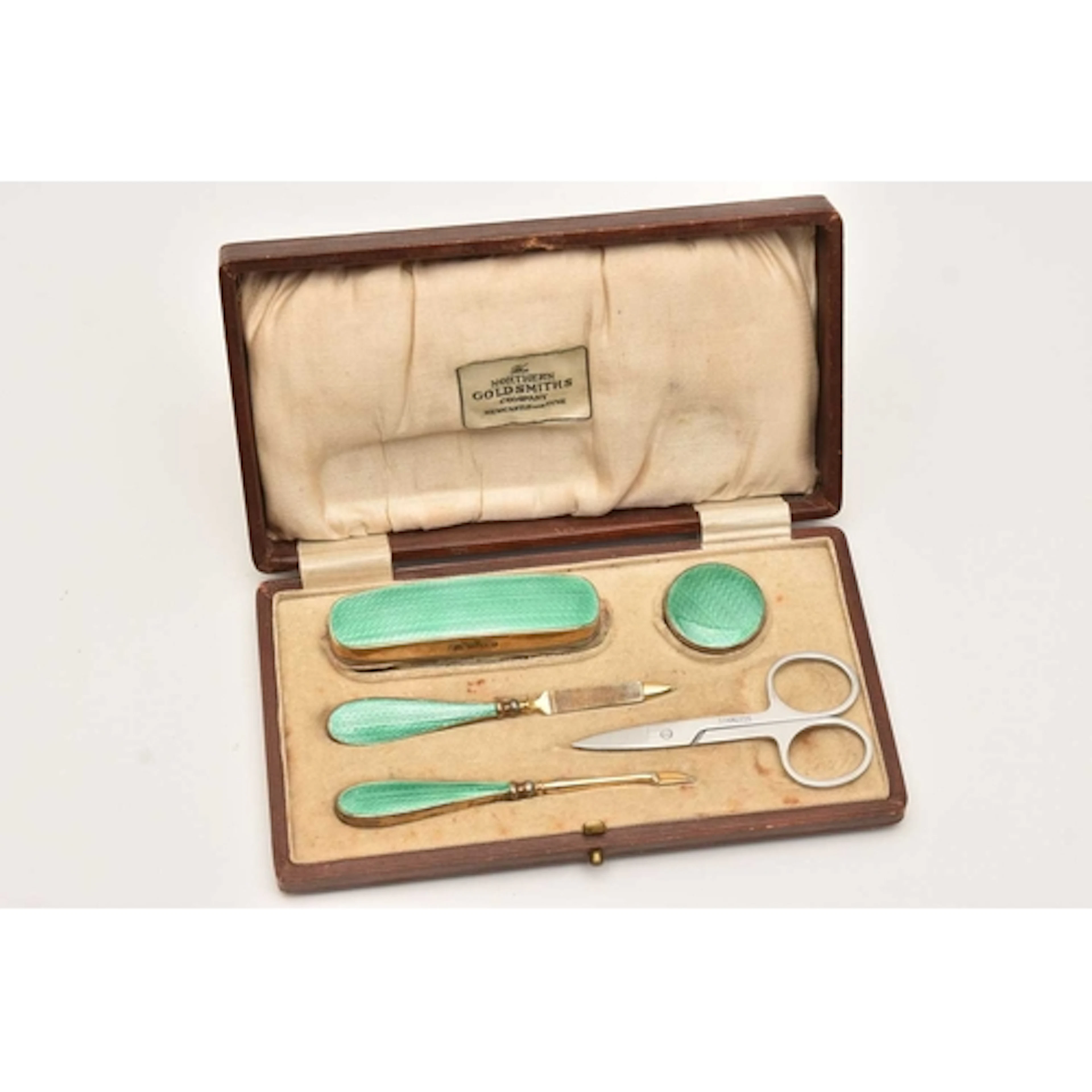 A CASED SILVER GILT AND GREEN ENAMEL ART DECO MANICURE SET, ...