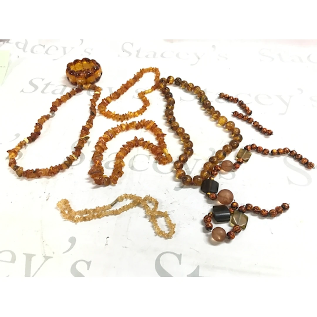 A collection of amber jewellery including bangles, necklaces...