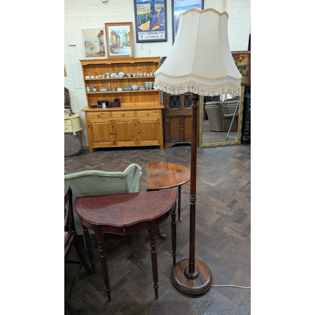 An oak standard floor lamp with cream fringed shade and a sm...