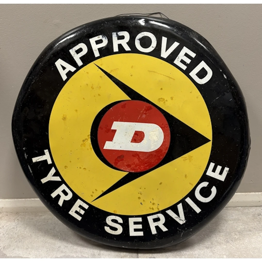 A circular vintage Dunlop "Approved Tyre Service" painted si...