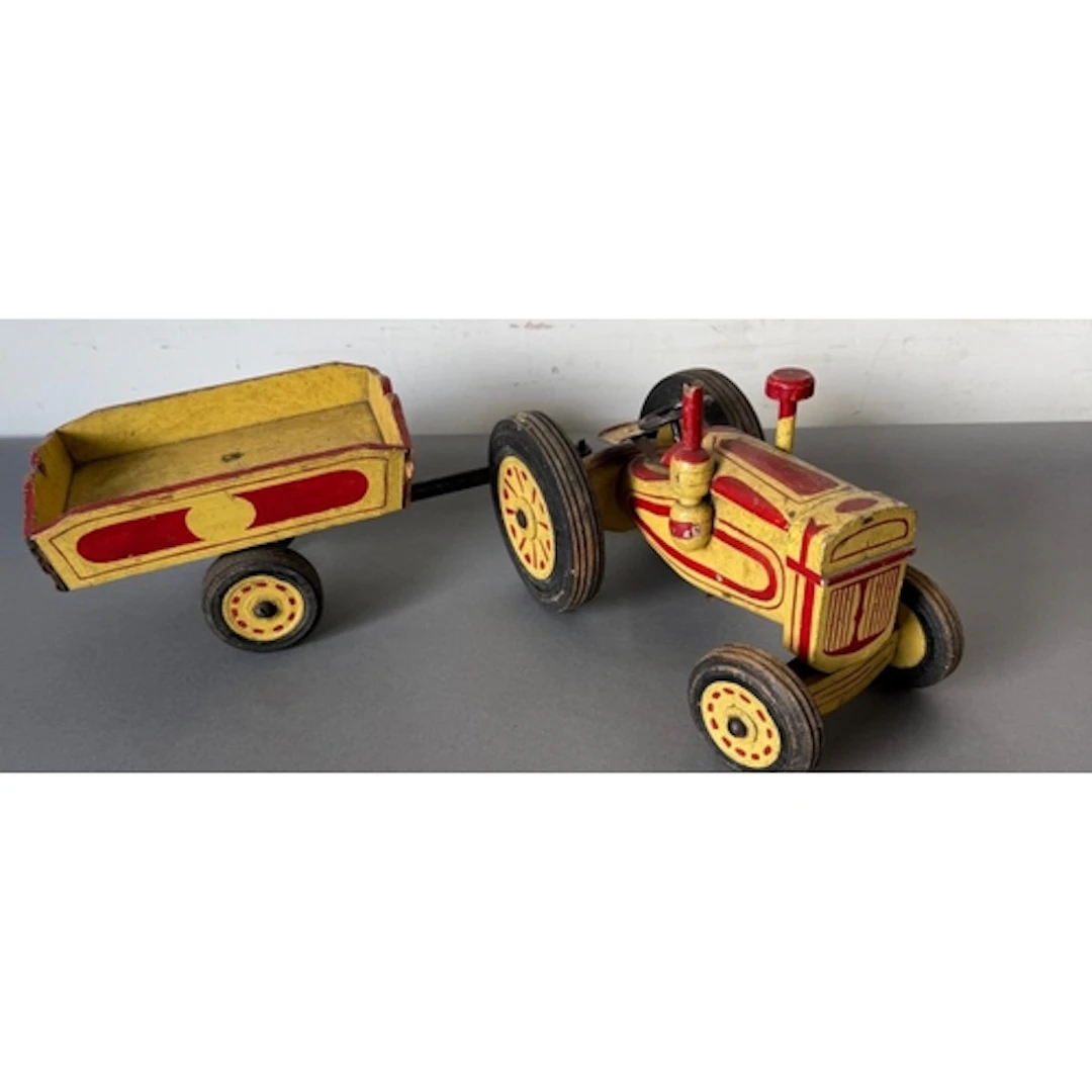 A handpainted wooden tractor and matching trailer.
