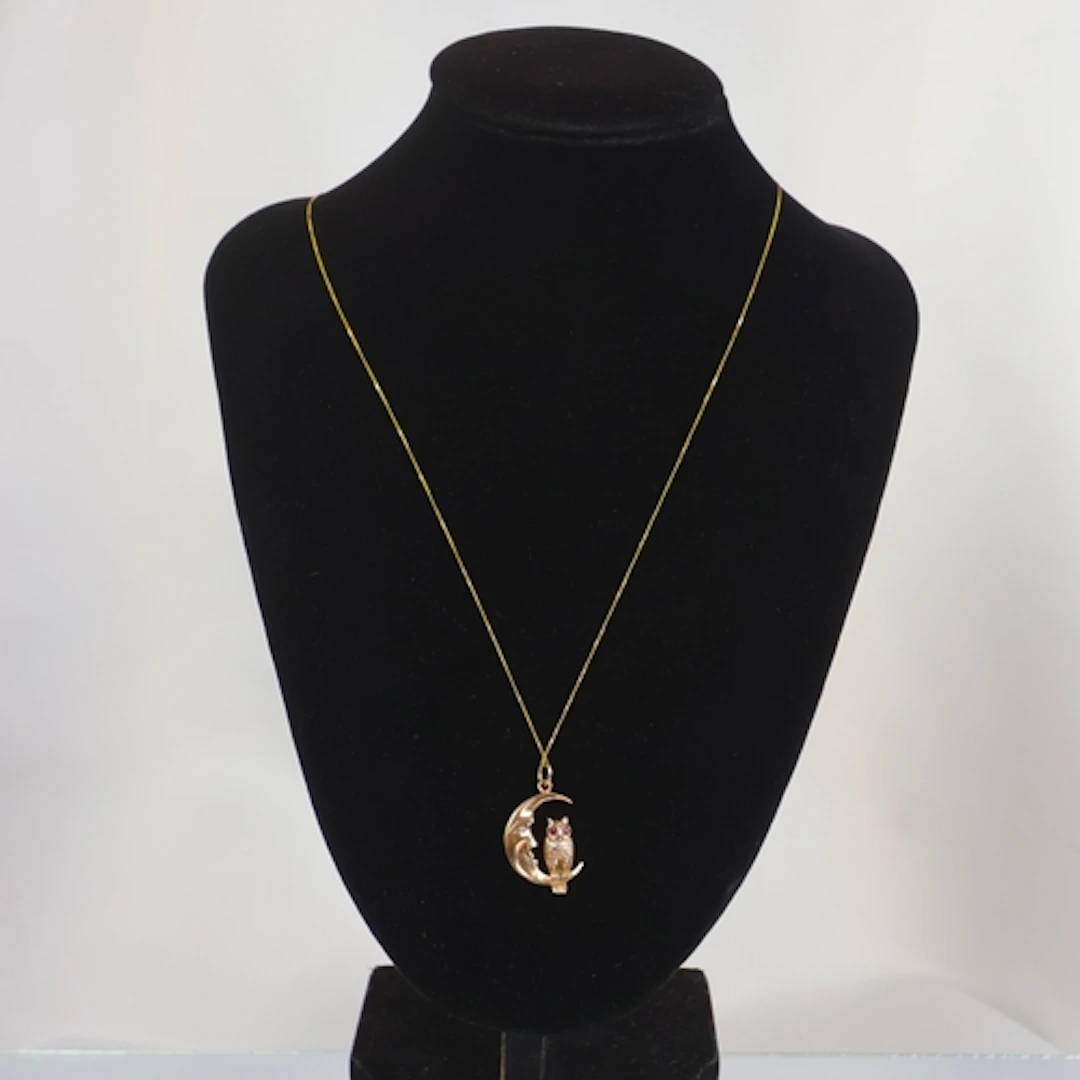 A contemporary 9ct gold pendant, the ruby and diamond set ow...