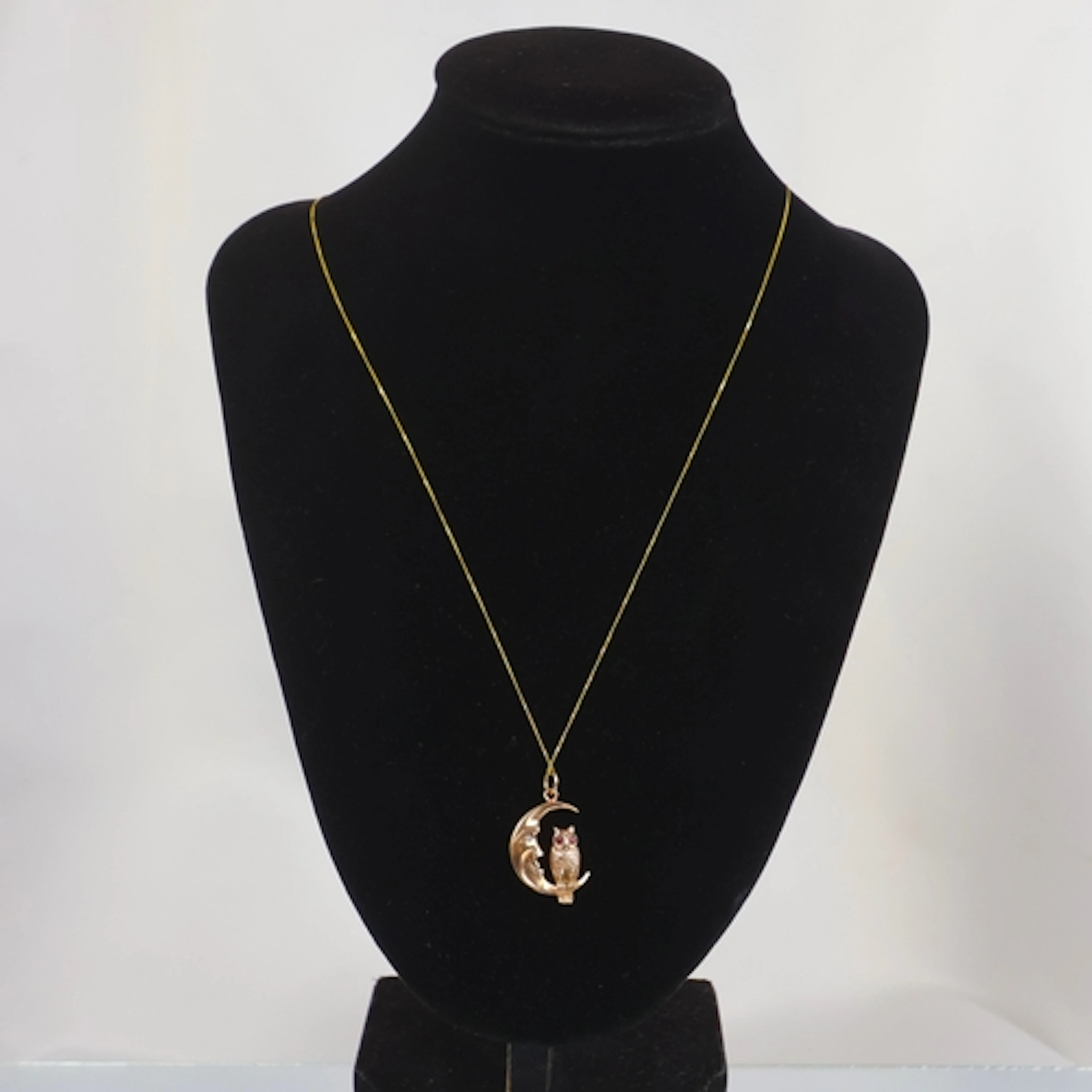 A contemporary 9ct gold pendant, the ruby and diamond set ow...