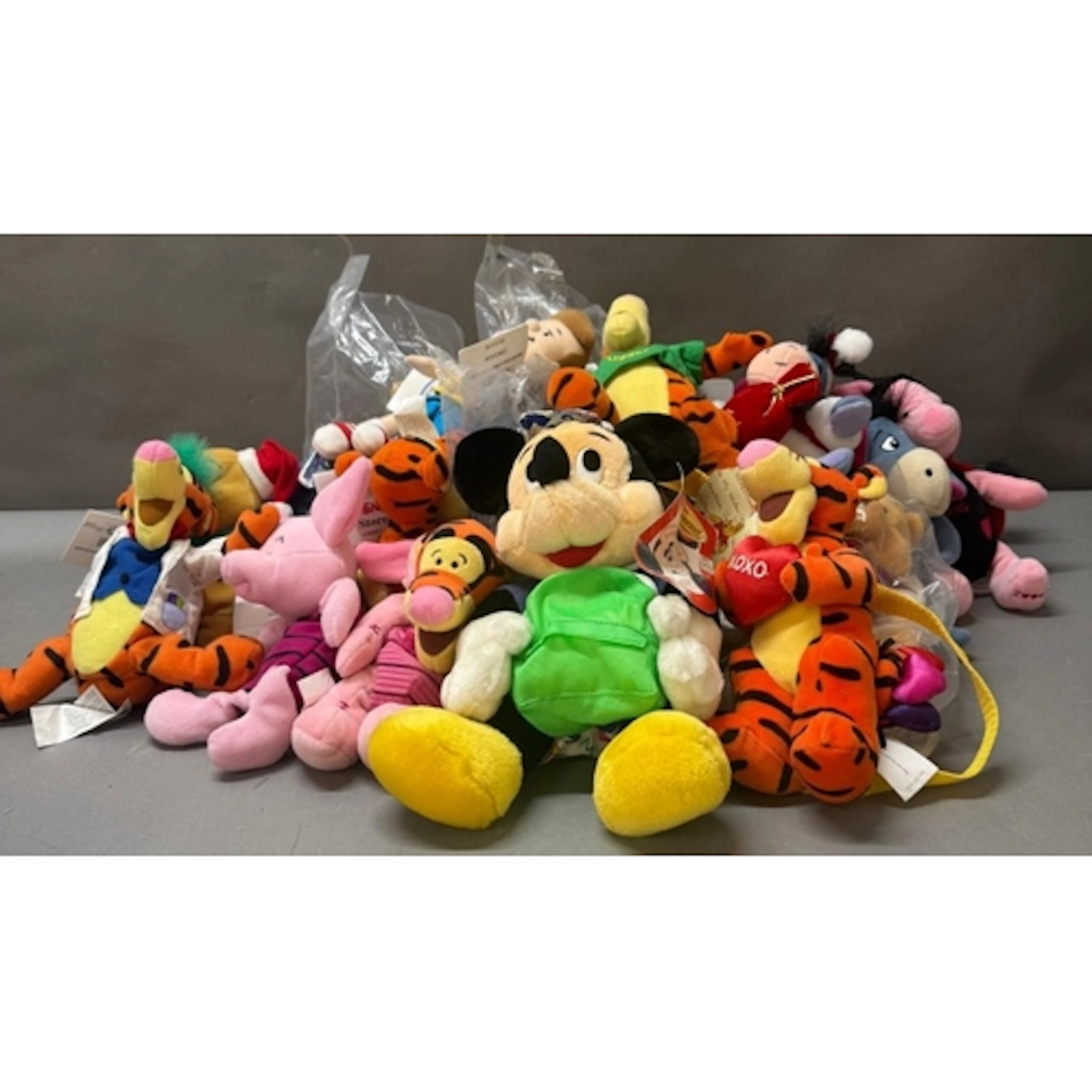 A quantity of Disney beenies to include Mikey and Piglet...