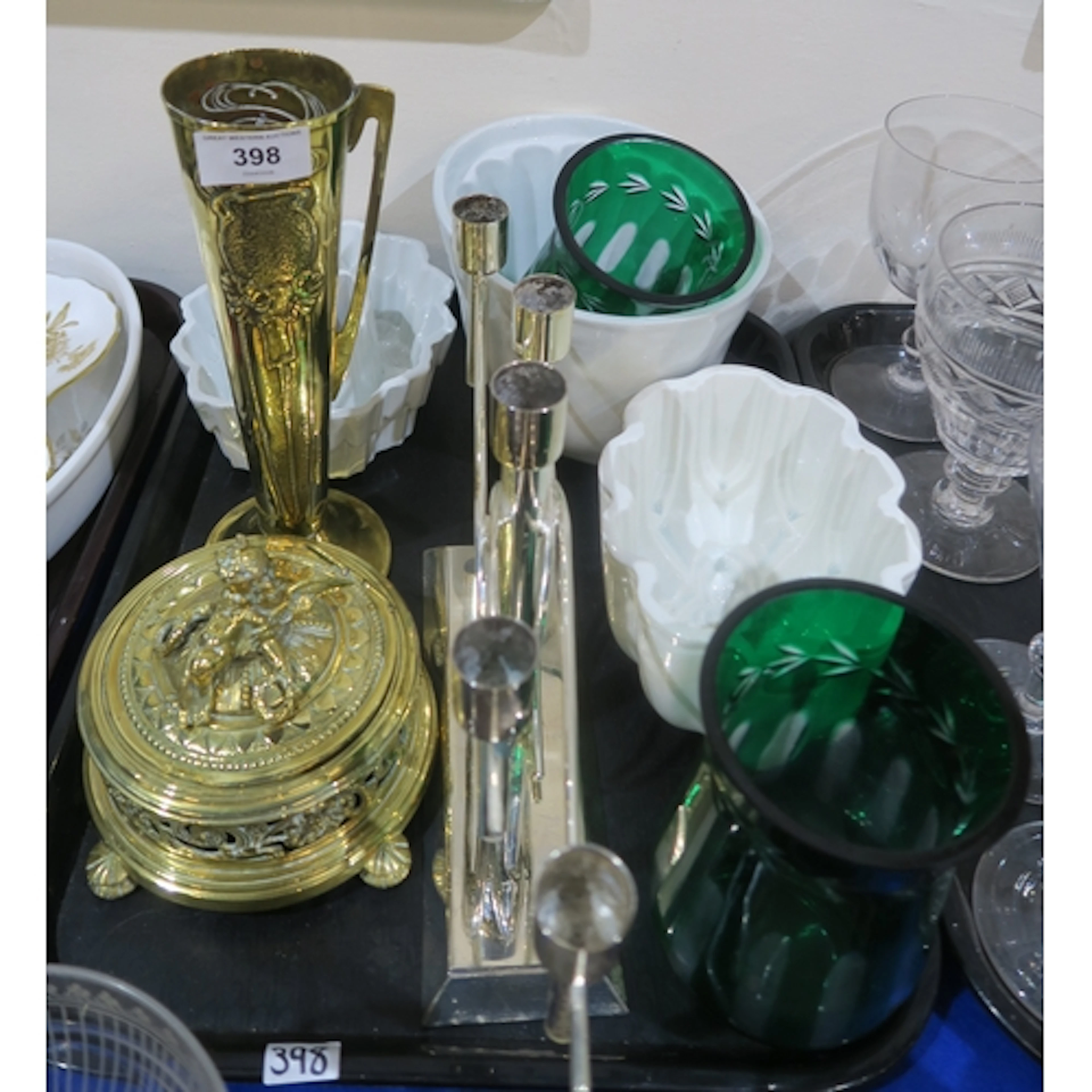 Two green flashed hurricane lamps, a silver plated candelabr...