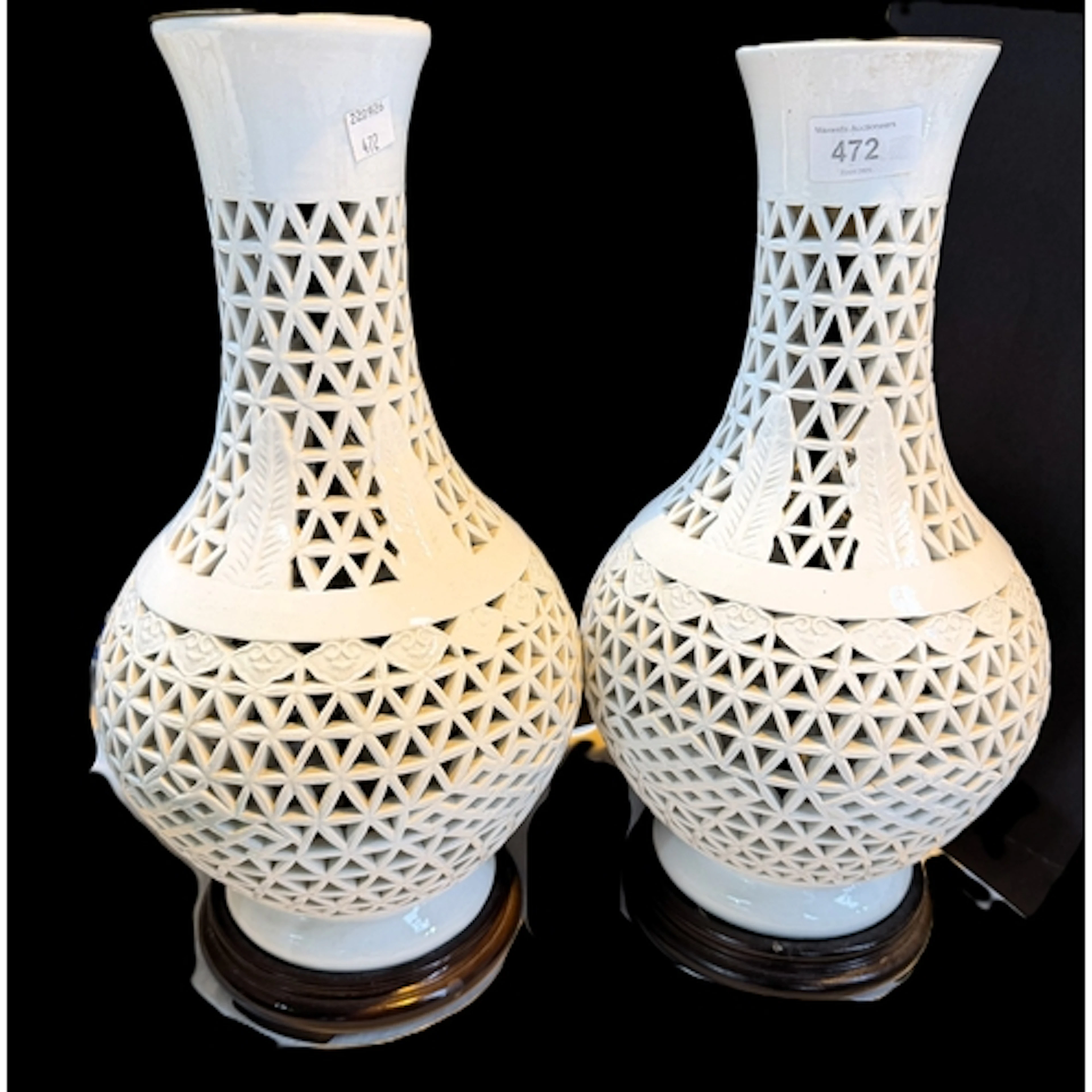 A pair of oriental style cream reticulated baluster table la...