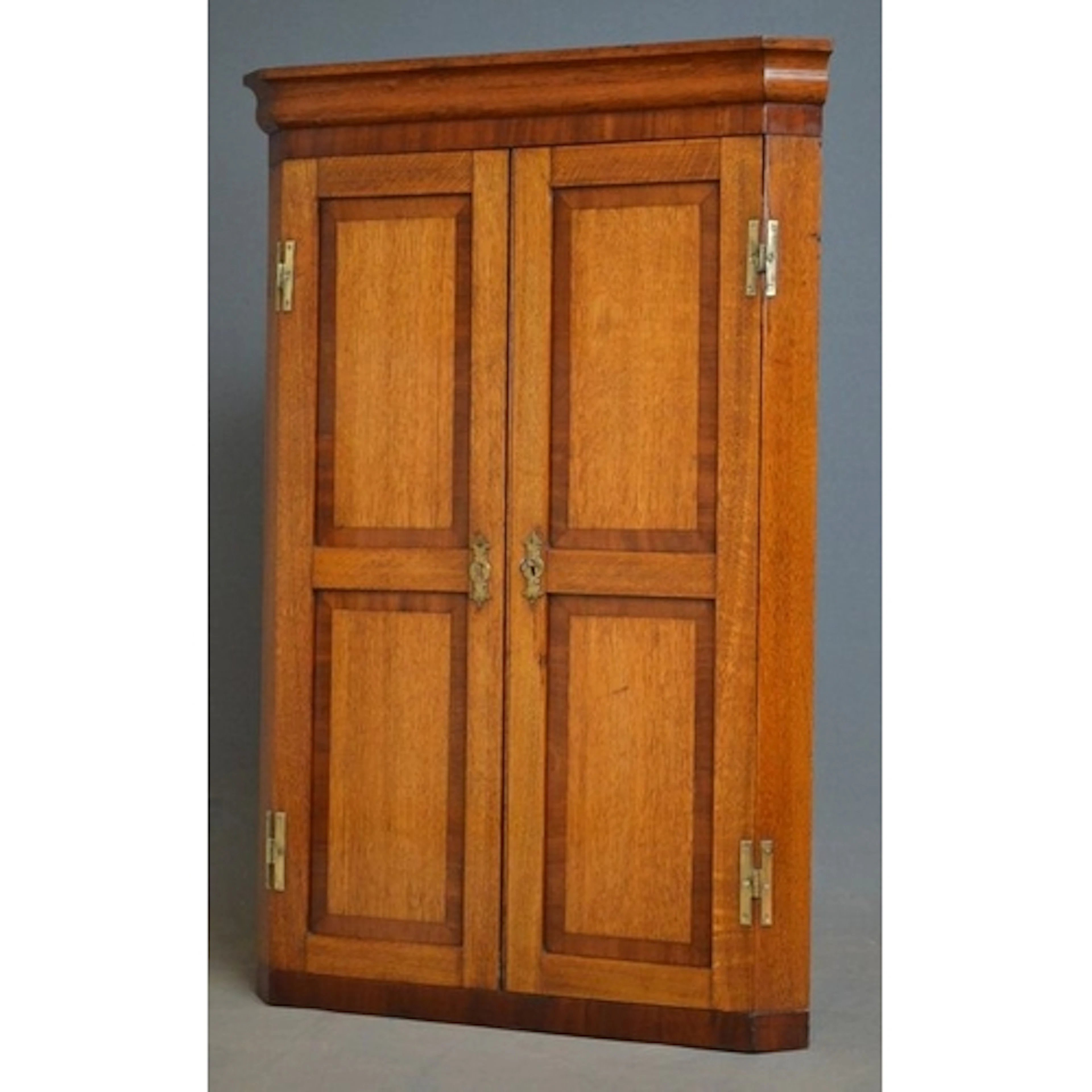 An attractive, Victorian oak and mahogany banded corner cupb...