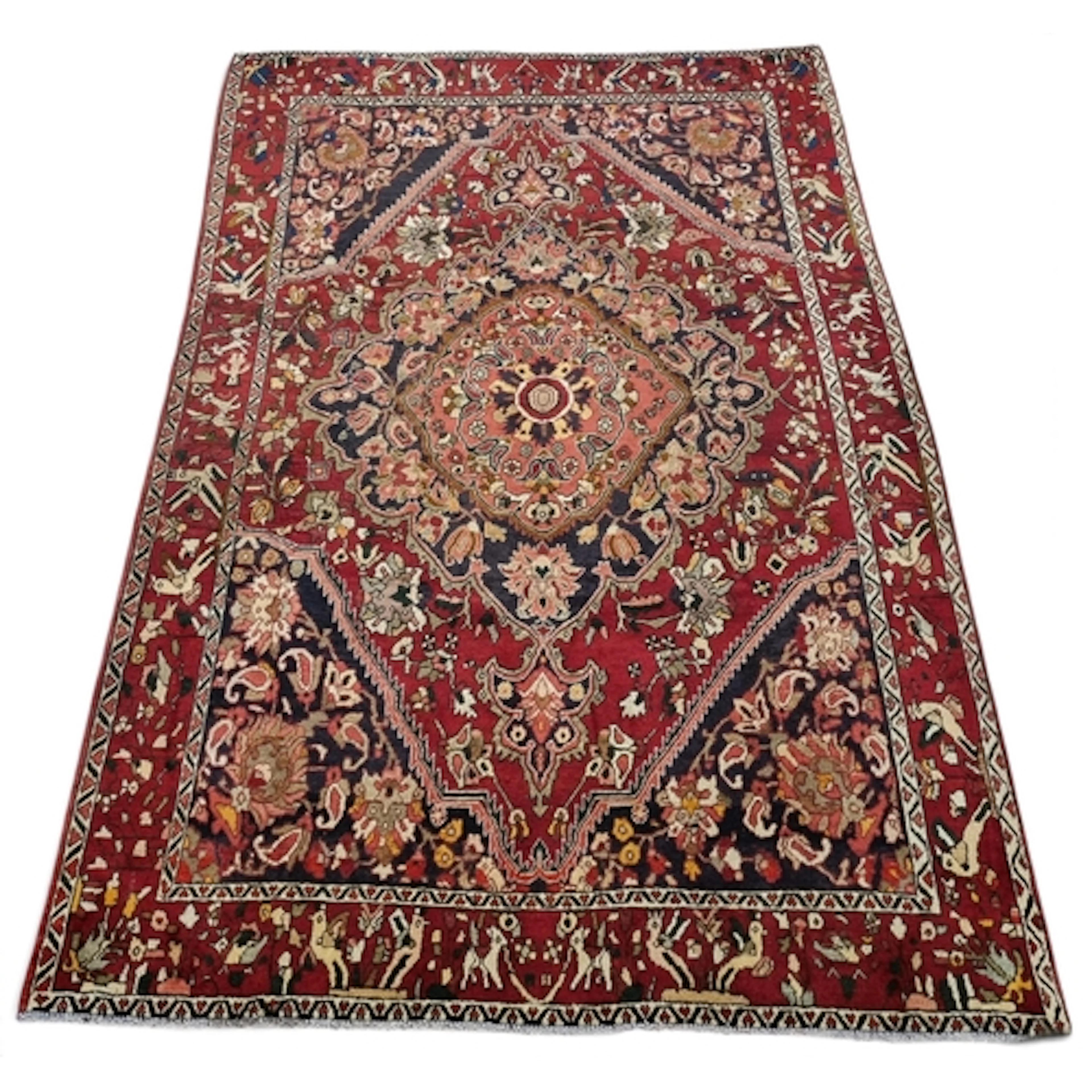 A rich Red ground traditional hand knotted village Bakhtiari...