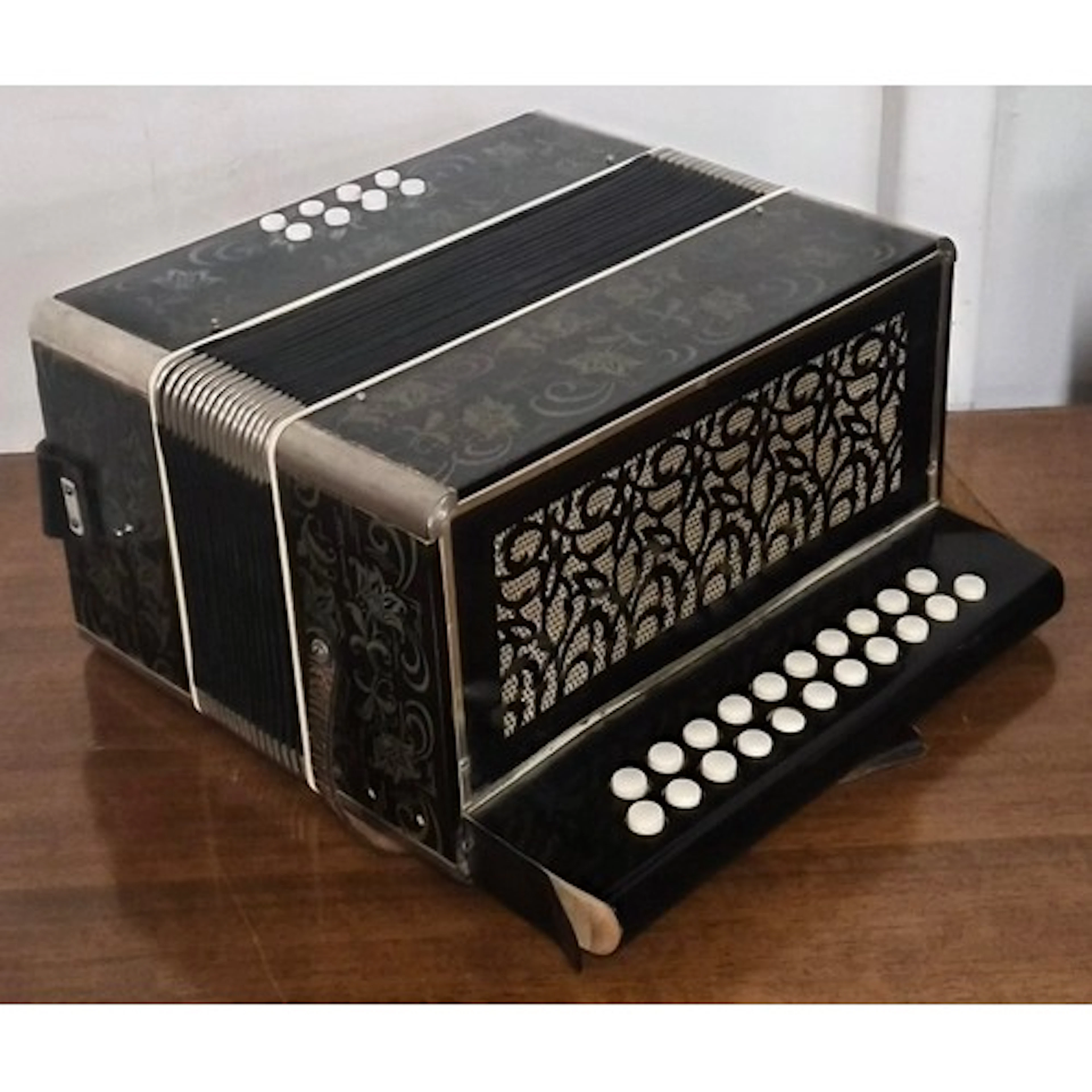 A vintage East German ebonised and faux ivory accordion