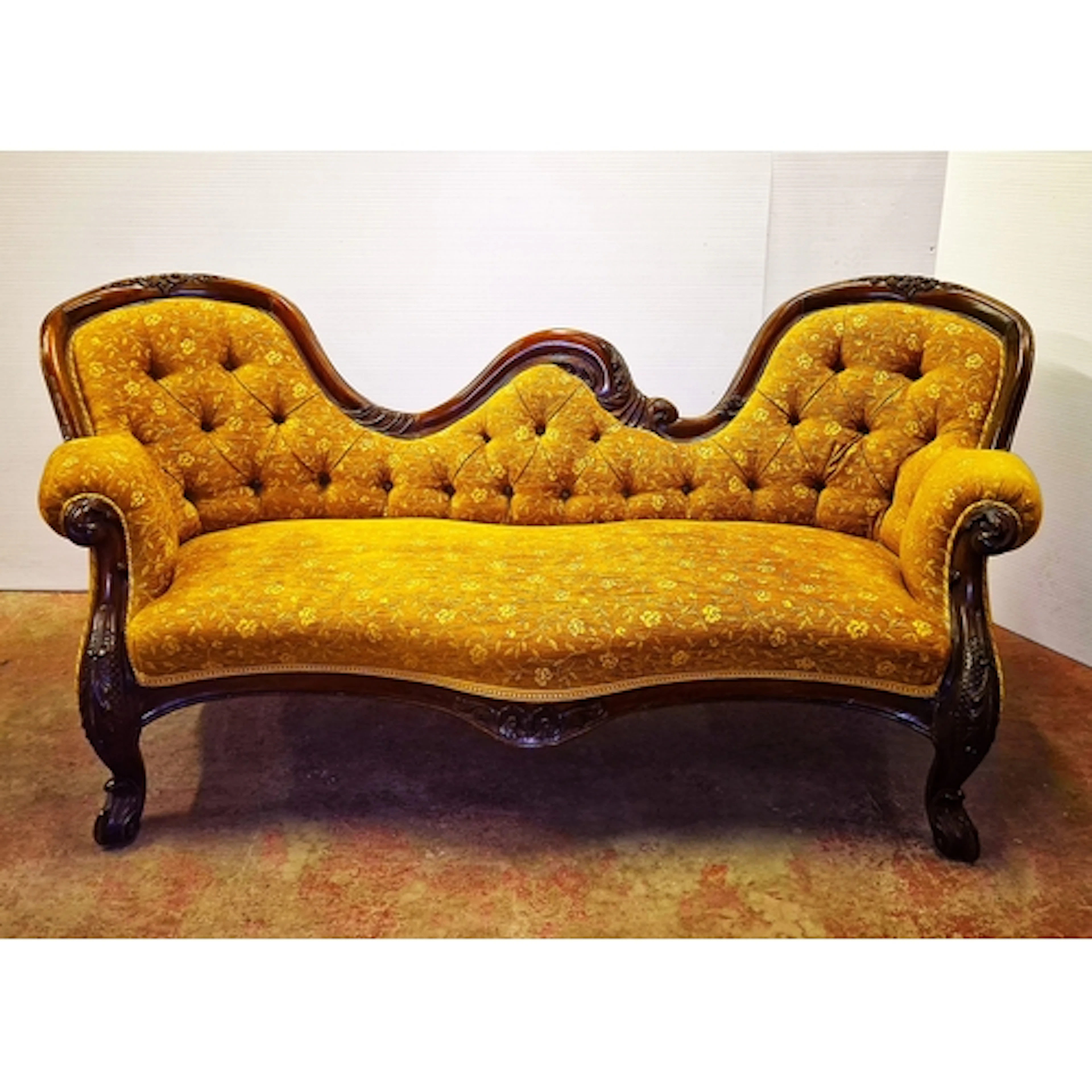 Victorian mahogany framed button back scroll sofa, upholster...