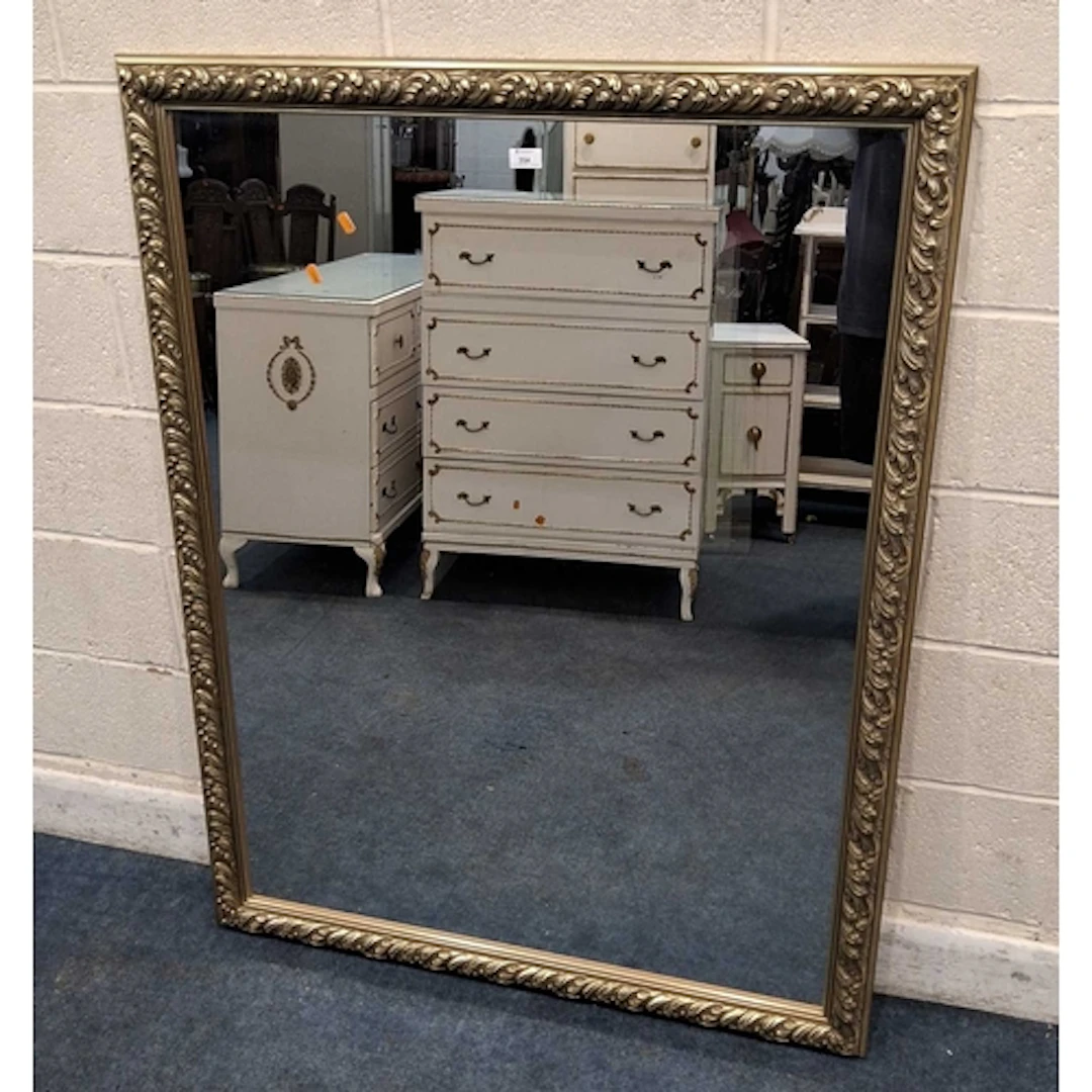 A GILT WOOD RECTANGULAR WALL MIRROR, with repeating foliate ...