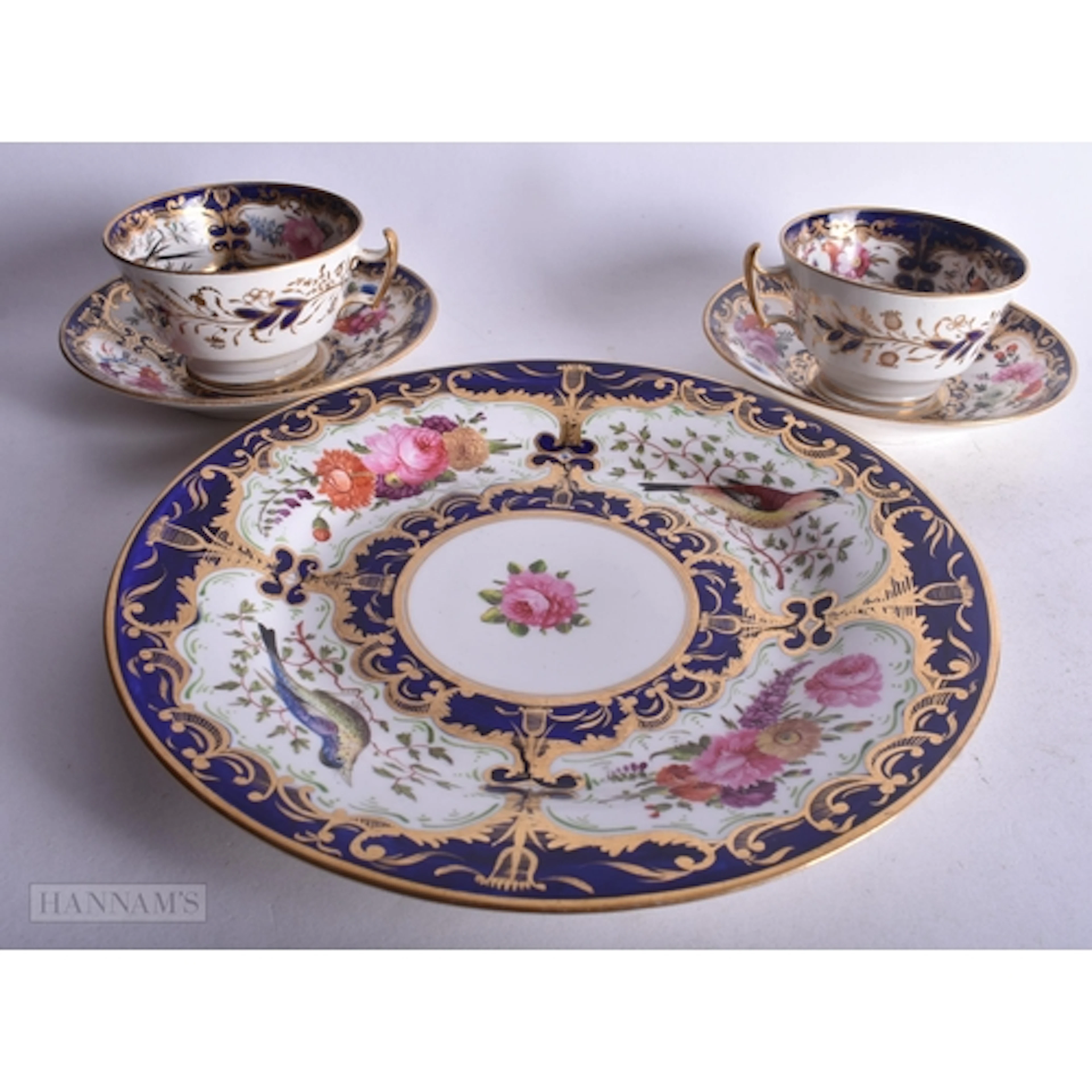 Coalport pair of teacups and saucers painted with wild birds...