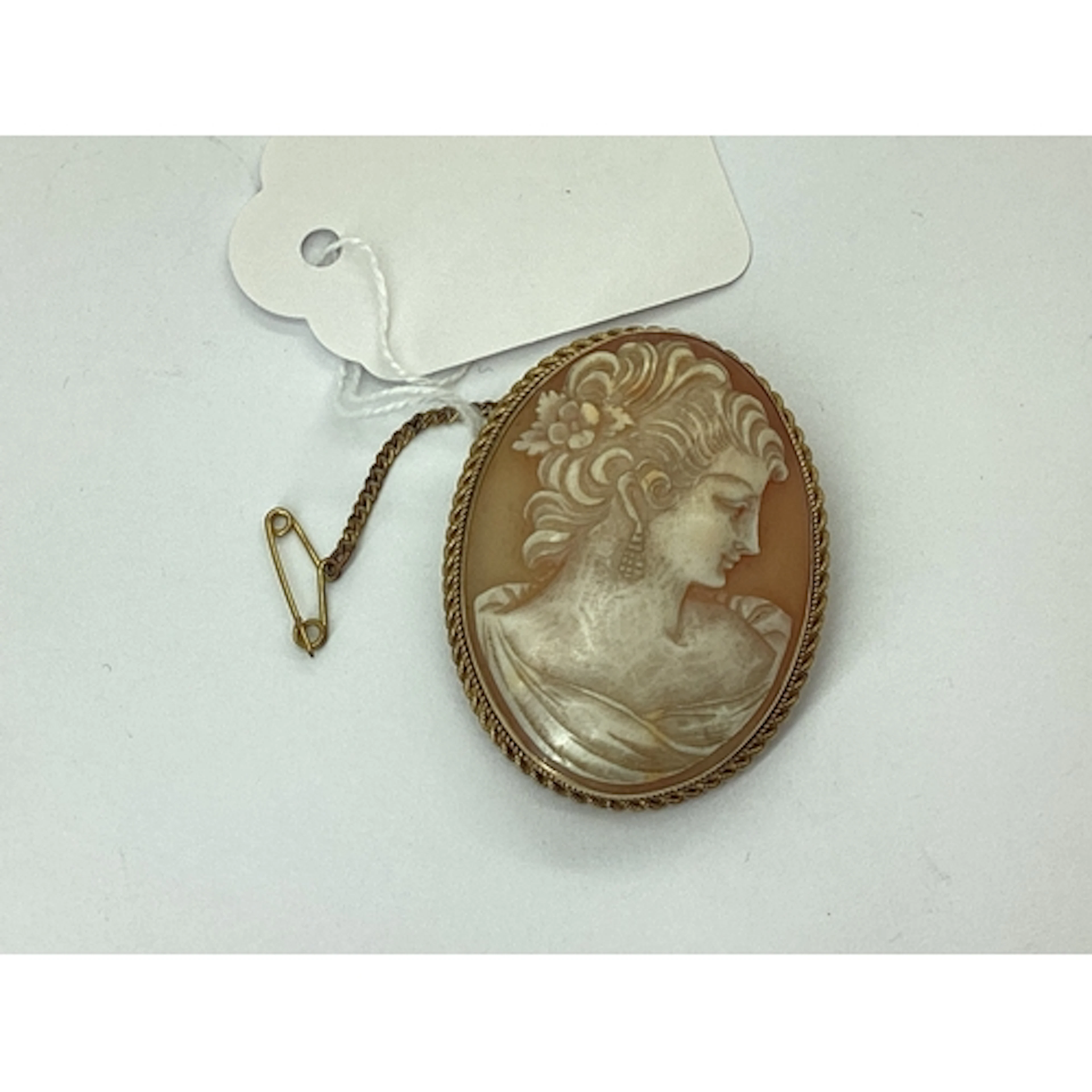 An Oval Shell Carved Cameo Brooch, depicting the side profil...