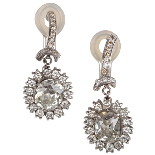 An attractive pair of diamond ear clips, each designed as a ...