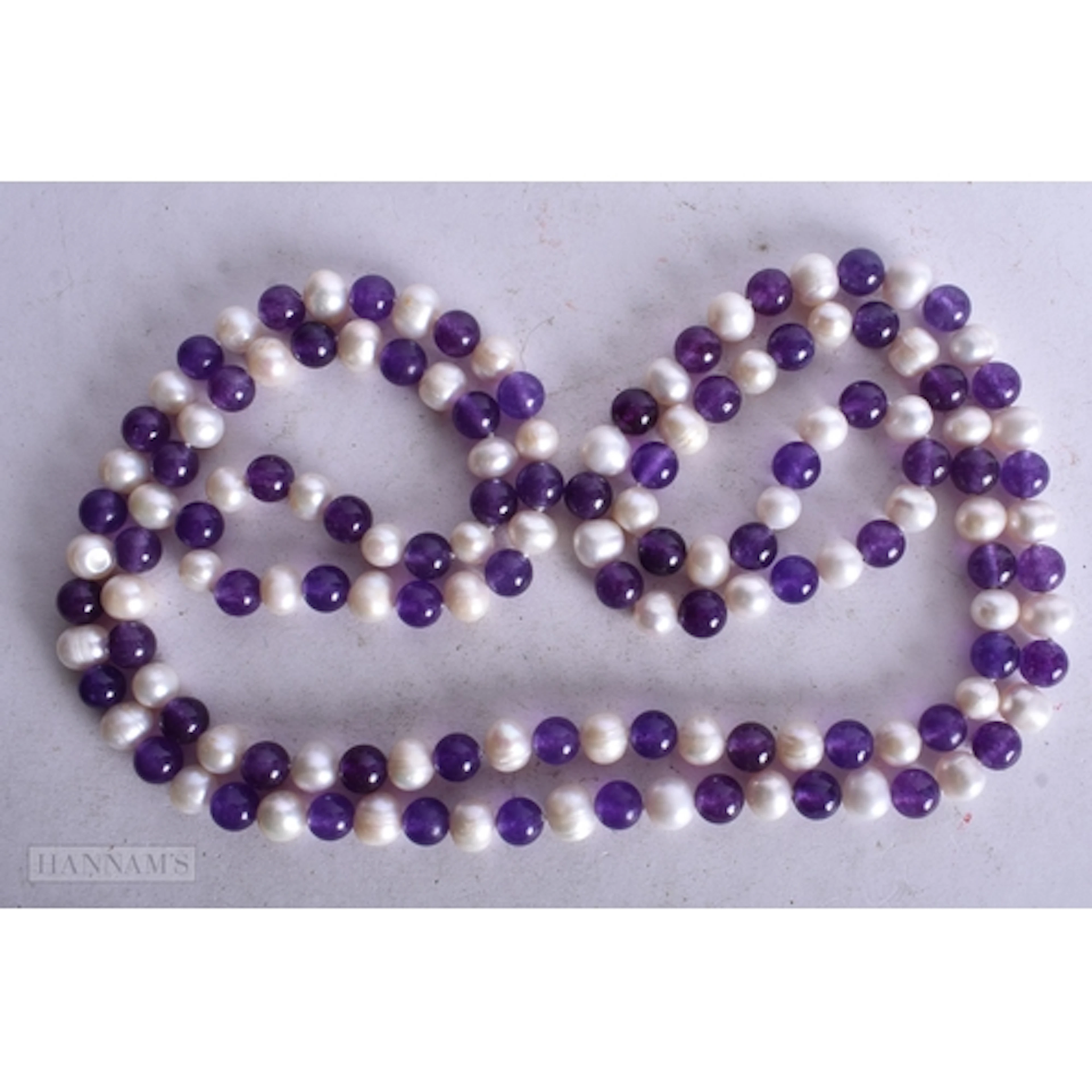 A AMETHYST AND PEARL STRING BEAD NECKLACE. 120 cm