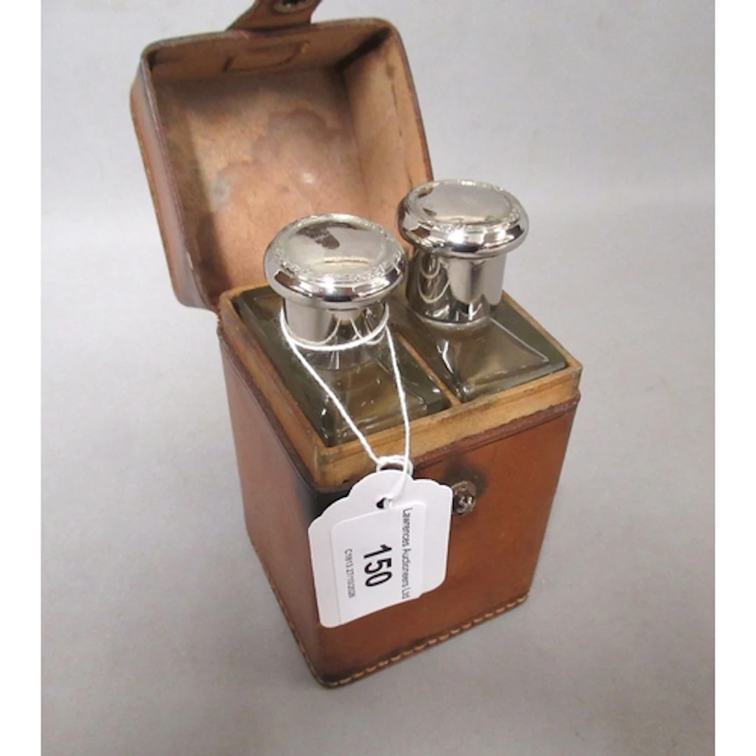 Square leather case, containing two glass cologne bottles