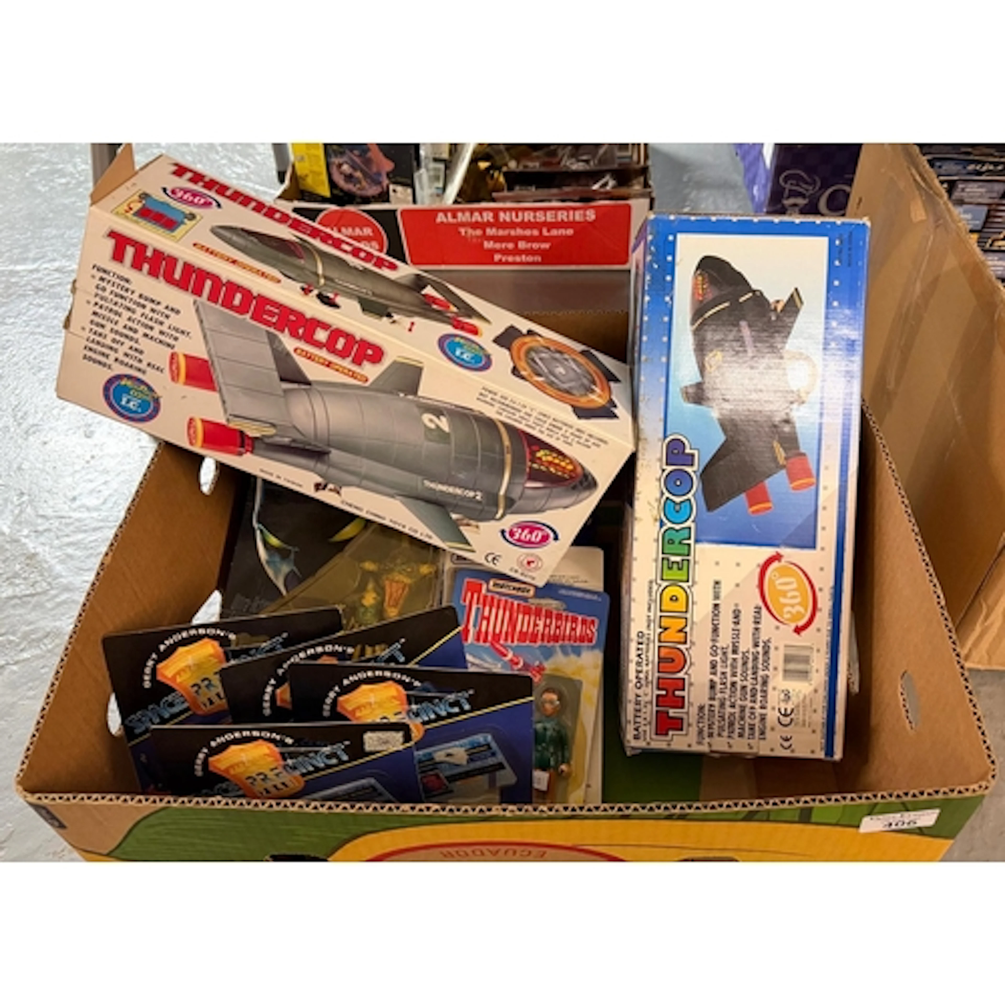 Box of toys to include: Matchbox Thunderbirds figurines in o...